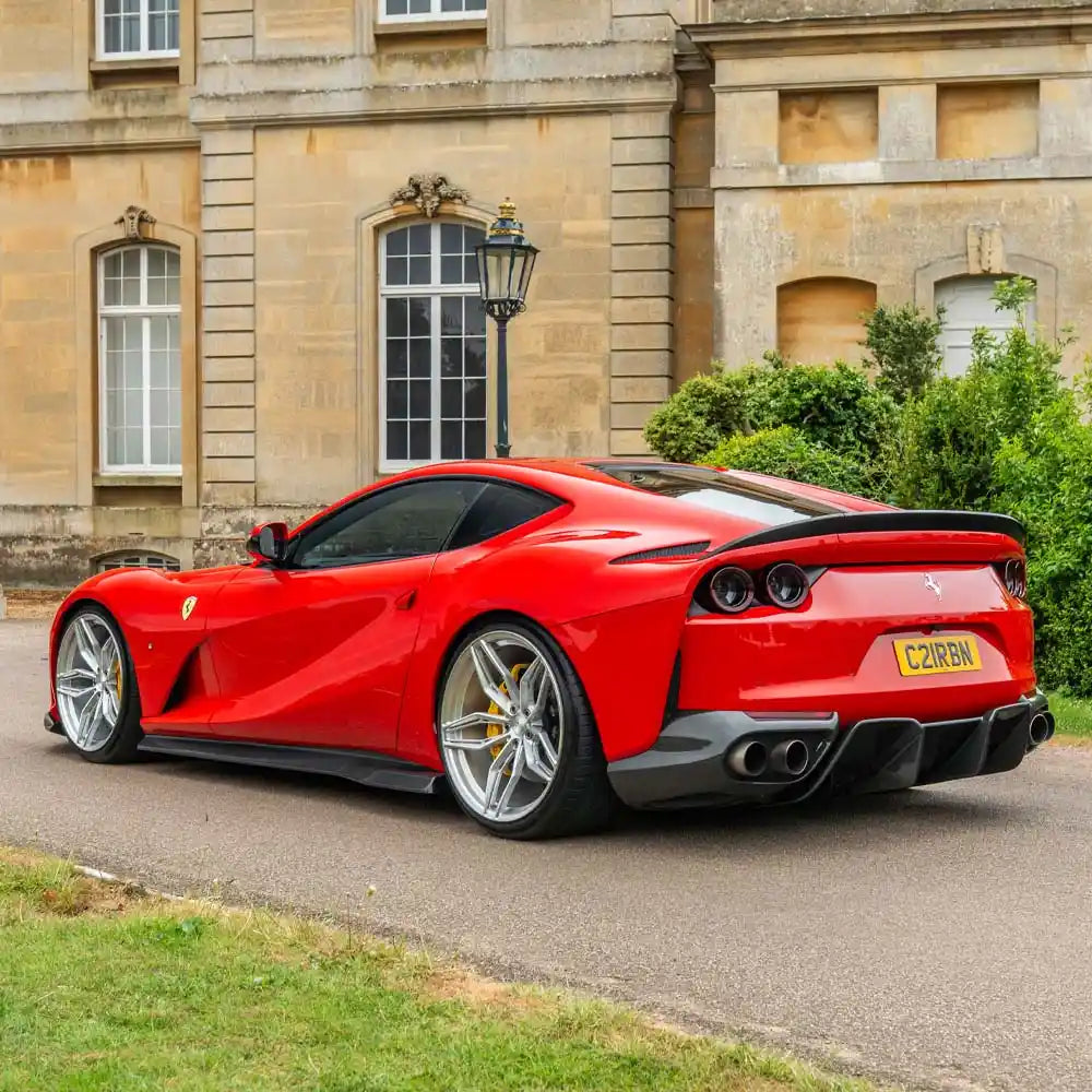 Ferrari 812 Superfast carbon fibre diffuser by CT Carbon, showing sleek aerodynamic design and textured carbon fibre surface.