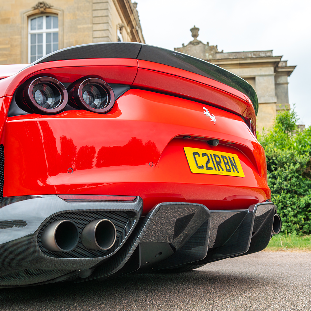 Ferrari 812 Superfast carbon fiber spoiler by CT Design showing sleek aerodynamic design and glossy carbon fiber finish.