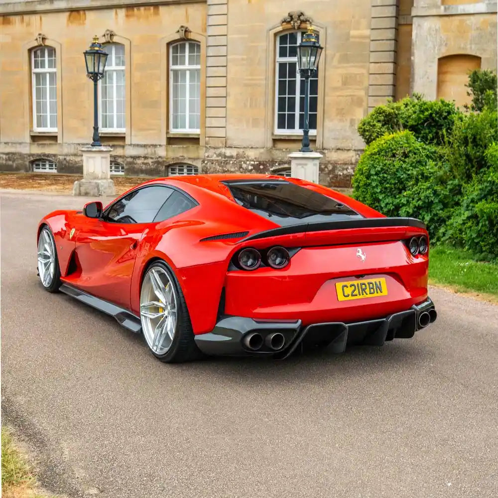 Ferrari 812 Superfast & GTS carbon fibre side skirt extension by CT Carbon, showing sleek, textured carbon fibre detail on the car's side.