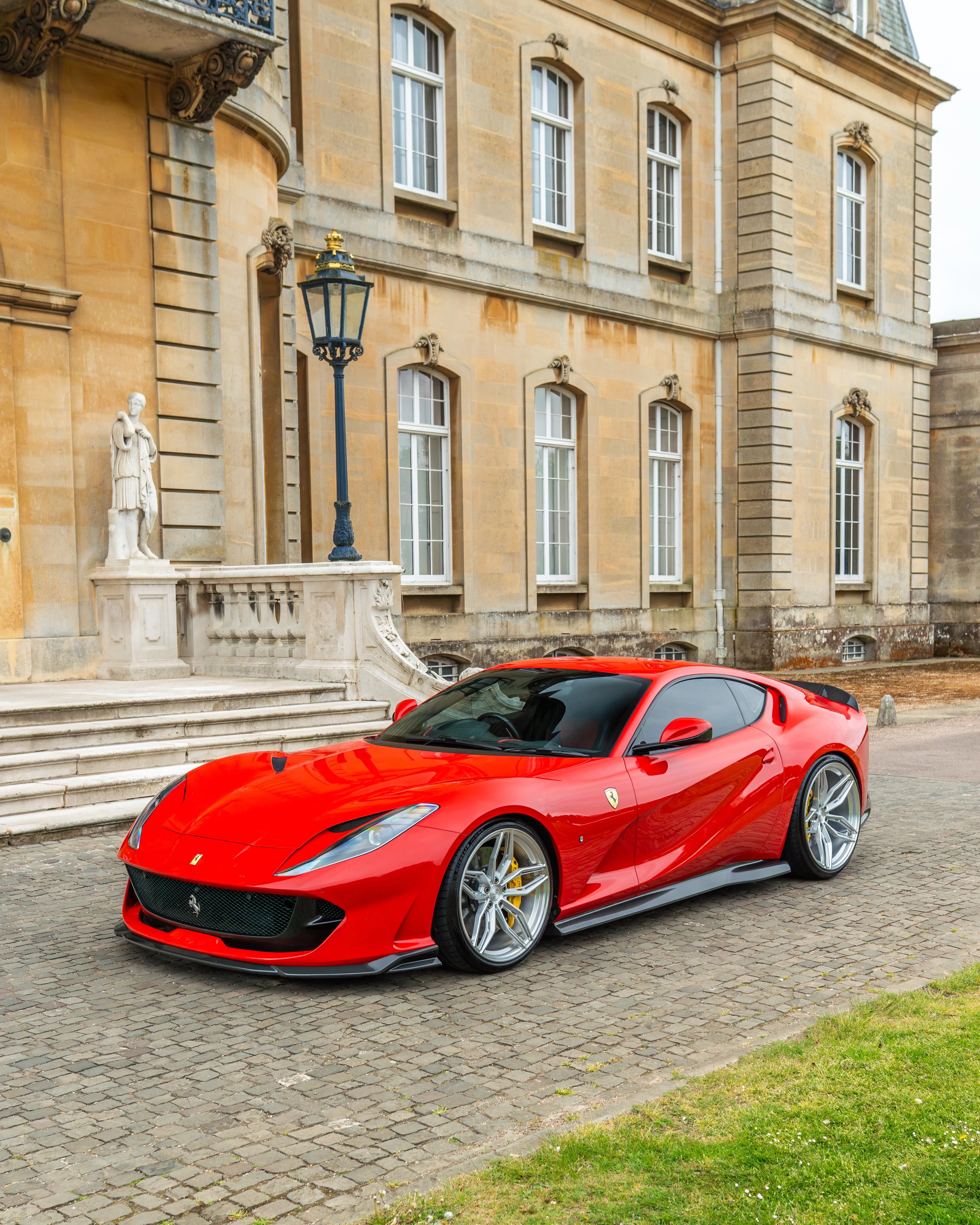 Carbon fibre kit for Ferrari 812 Superfast by CT Design, featuring splitters and aerodynamic enhancements in a sleek carbon finish.