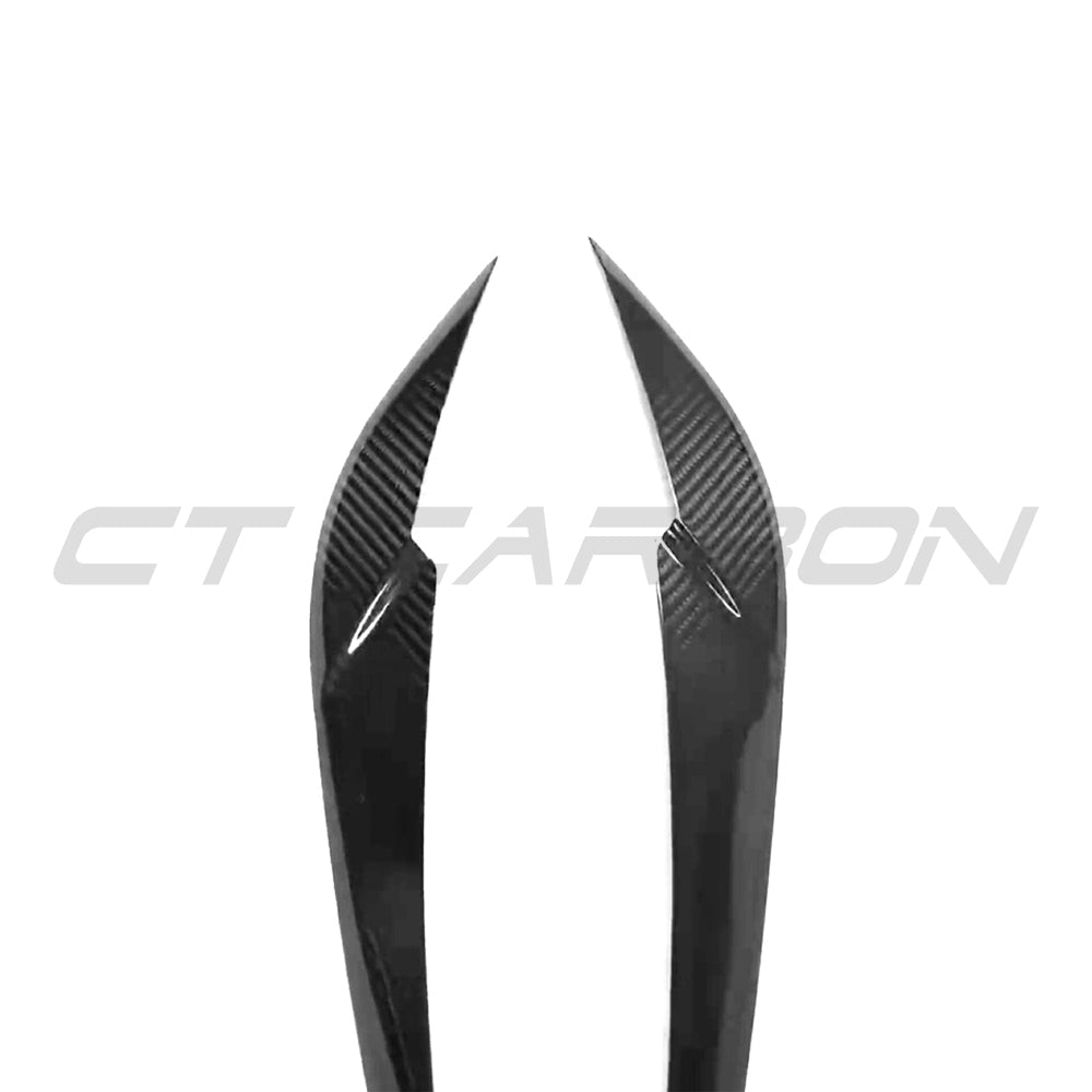 BMW M3 & M4 G8X carbon fibre headlight eyebrow accessory by CT Carbon, shown on a sleek car with close-up detail.