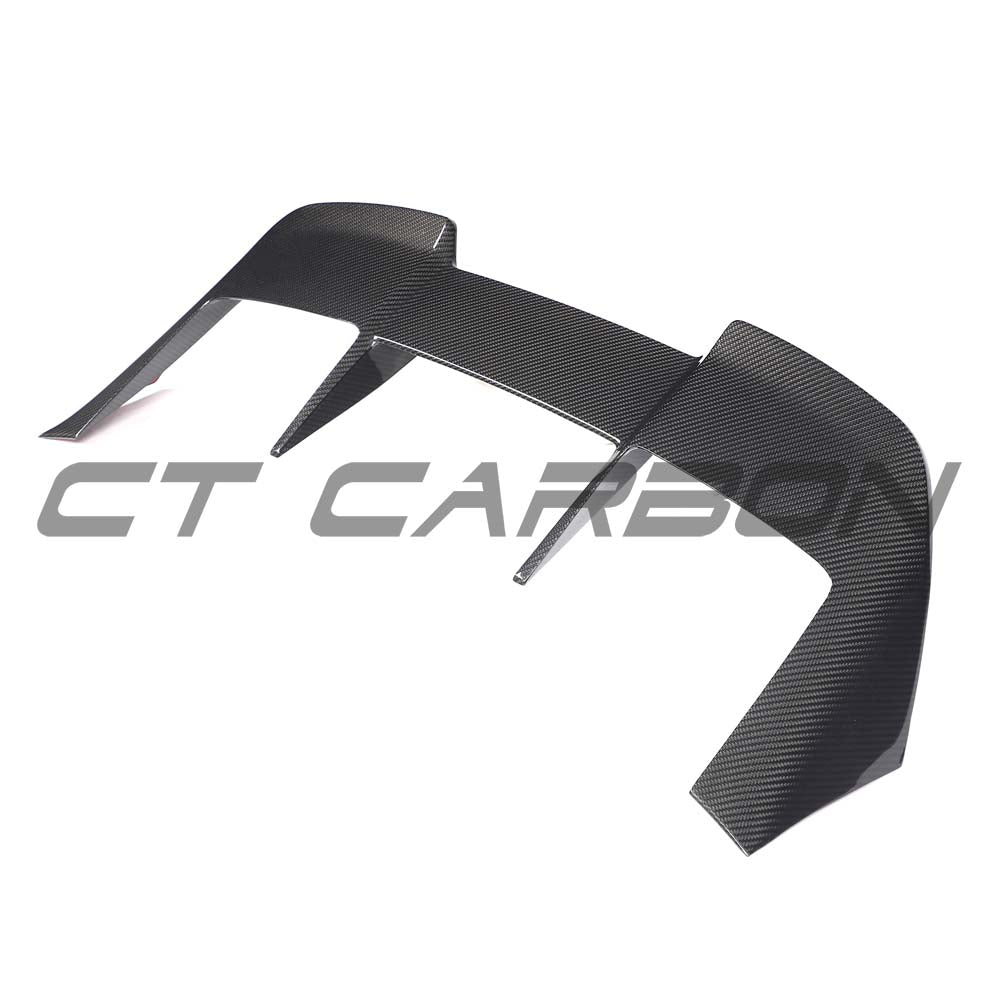 BMW G99 M5 Touring 2024 carbon fibre spoiler by CT Carbon, shown on the car's rear, emphasizing sporty aerodynamics and lightweight design.
