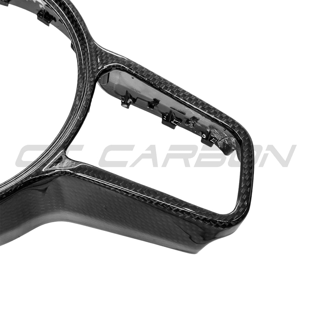 CT Carbon Porsche 911, Cayman, Boxster, Cayenne, Macan steering wheel trim accessory showcasing a sleek carbon fiber finish.