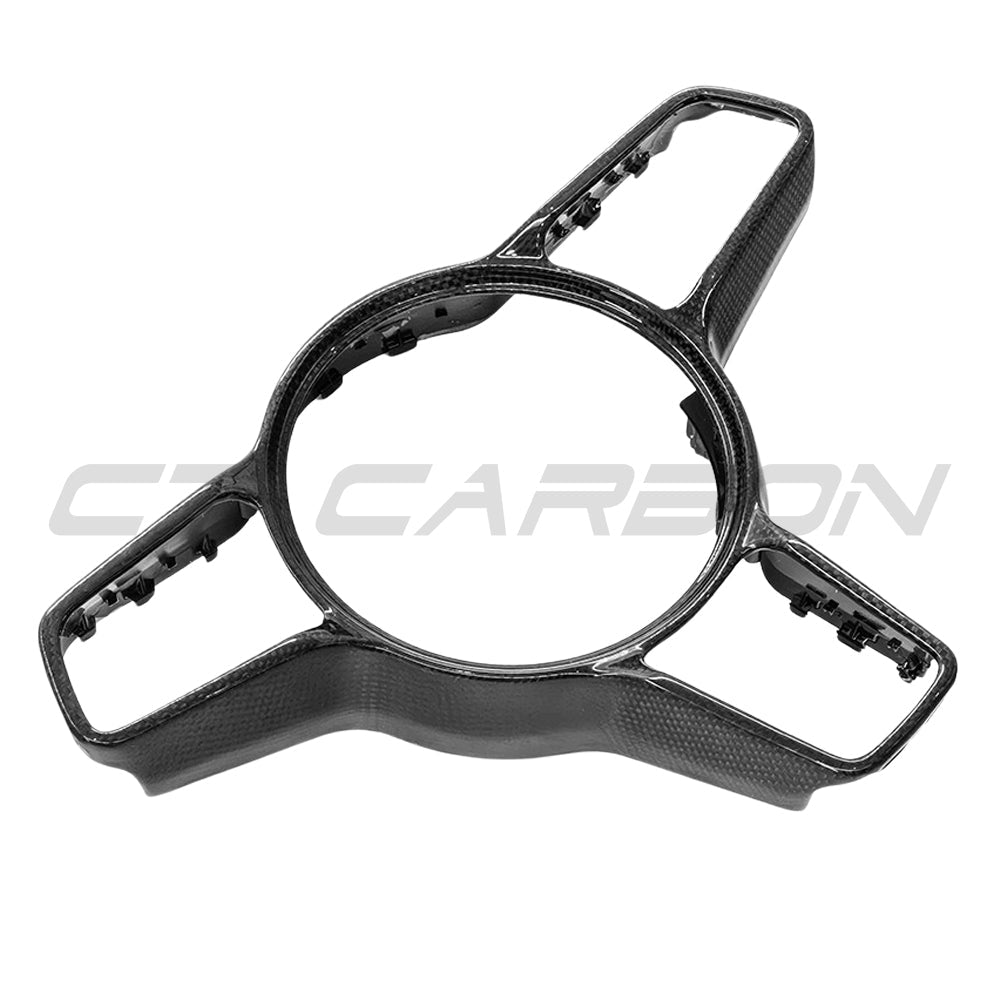 CT Carbon Porsche 911, Cayman, Boxster, Cayenne, Macan steering wheel trim accessory showing a sleek carbon fiber finish.