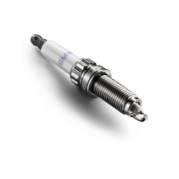 Genuine BMW S58 spark plugs, model 12125A4EF60, showing the metal and ceramic components of the high-performance ignition plugs.