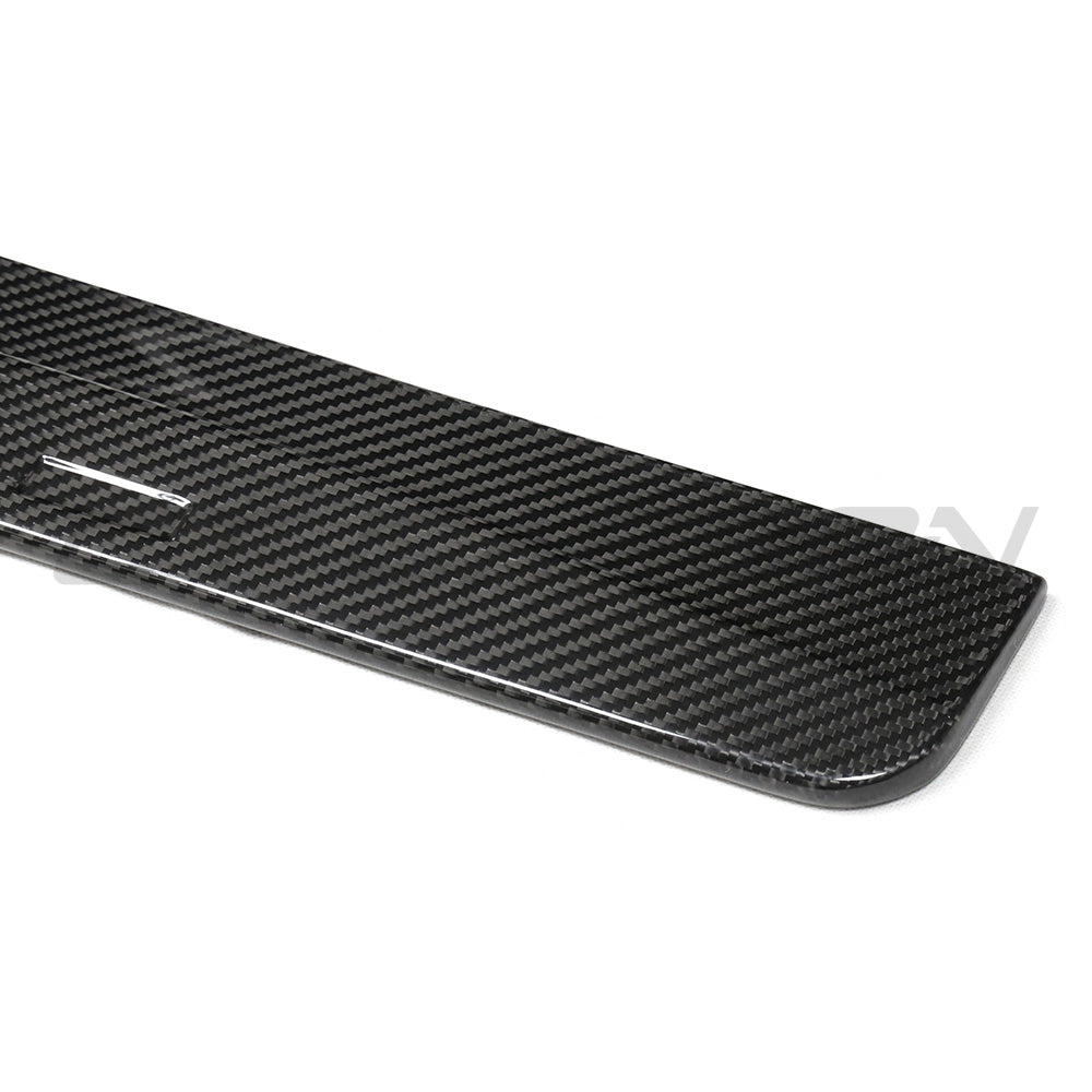 BMW G87 M2 carbon fiber side skirts by CT Carbon, showing sleek, aerodynamic design and textured carbon fiber surface.