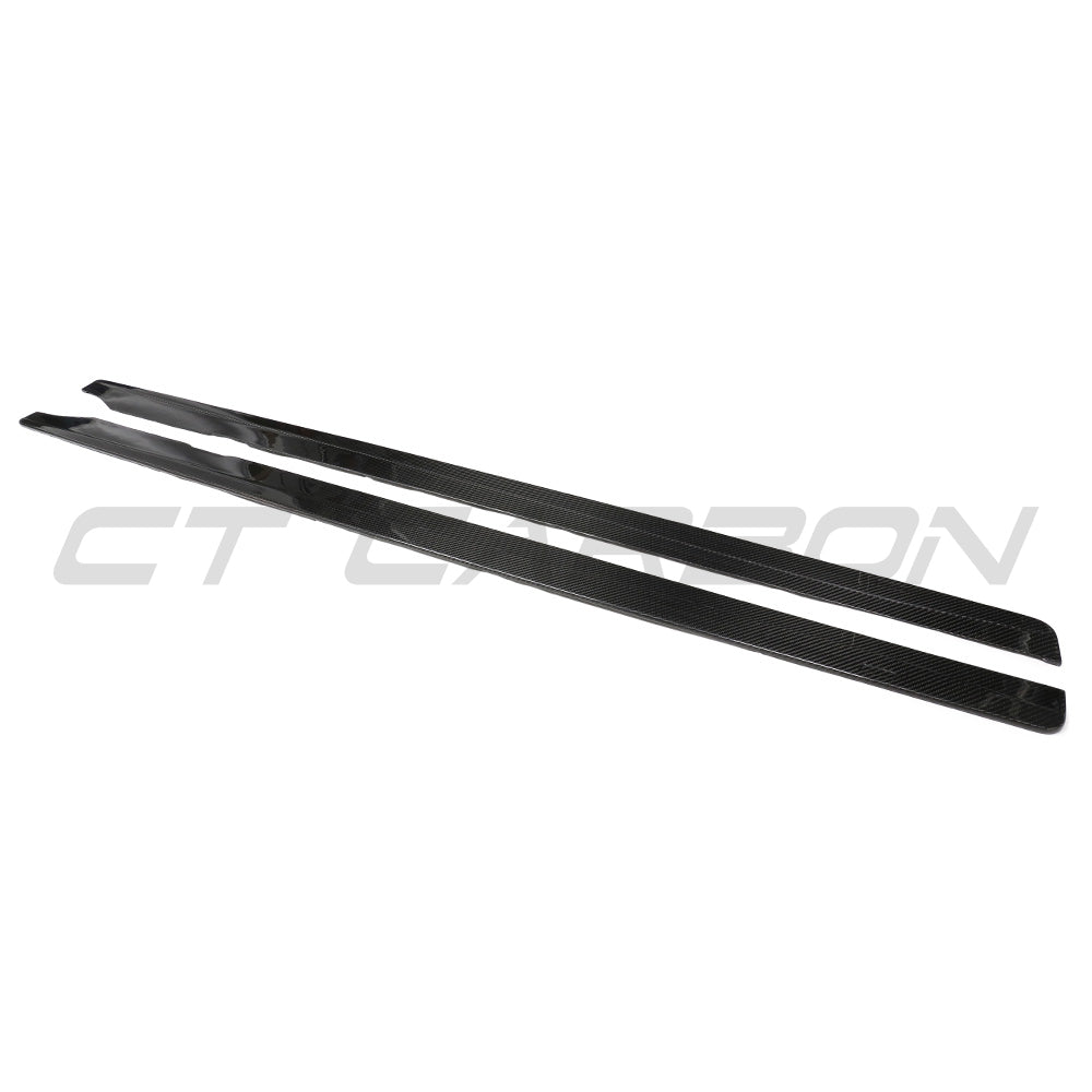 BMW G87 M2 carbon fibre side skirts by CT Carbon, showing sleek, aerodynamic design and textured carbon fibre surface.