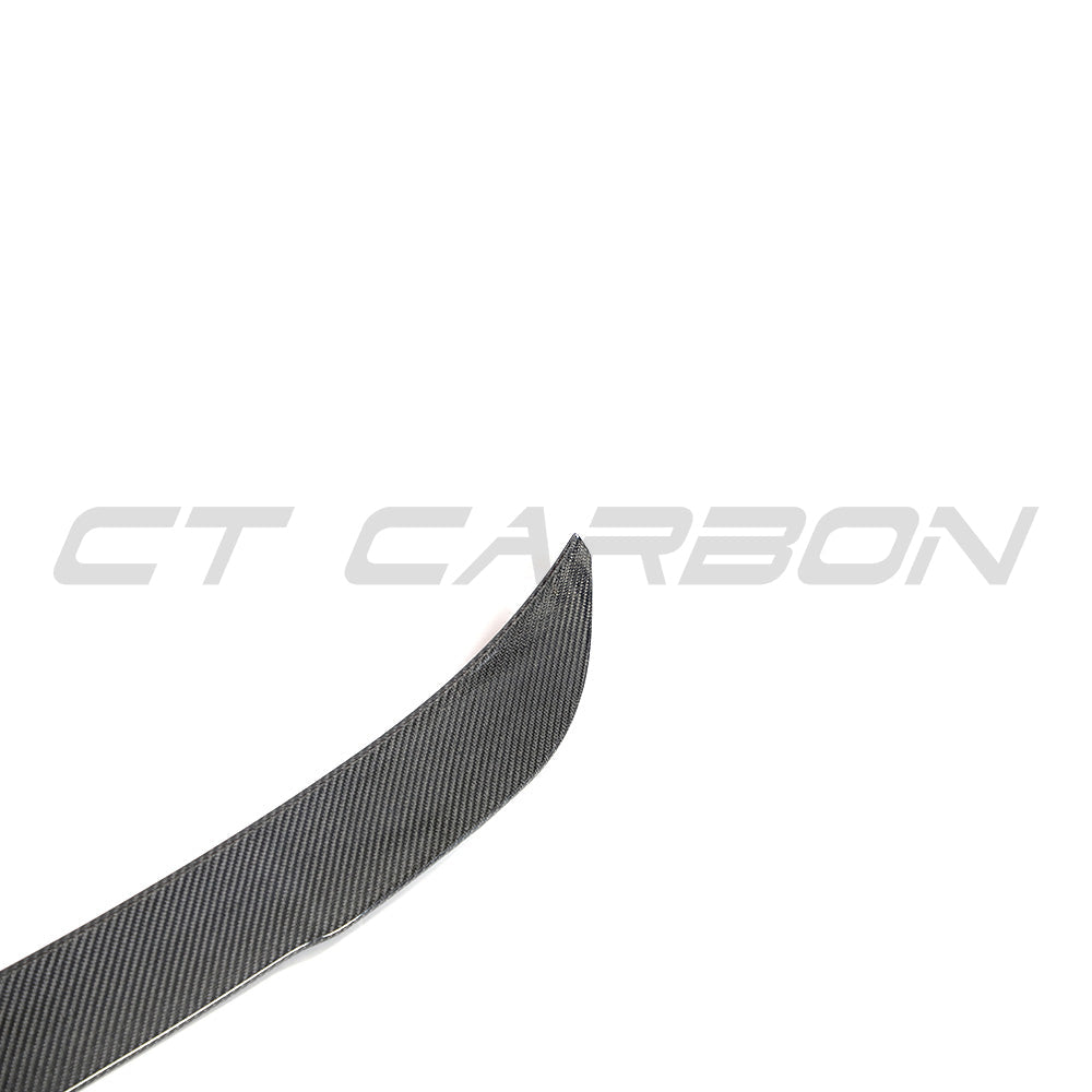 BMW G02 X4 and F98 X4M carbon fibre spoiler by CT Carbon, showcasing sleek aerodynamic design on the vehicle's rear.