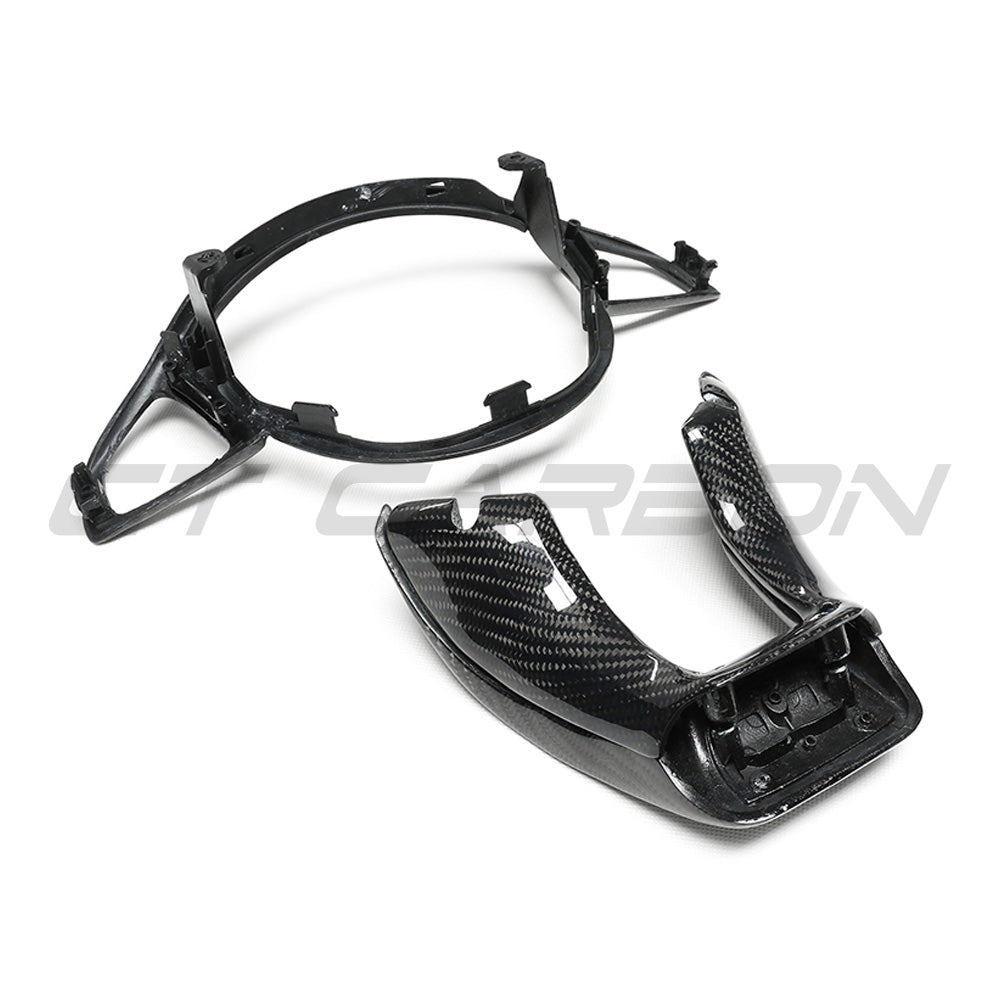 Mercedes AMG carbon fiber steering wheel trim accessory by CT Carbon, close-up of sleek black carbon fiber finish on car interior.