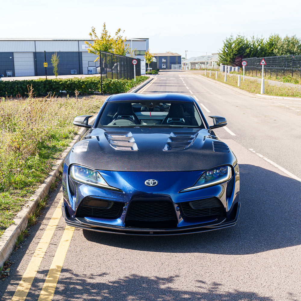 Full view of a 2019+ Toyota Supra A90 CT Carbon V2 full carbon fiber kit installed, showcasing sleek, lightweight automotive components.