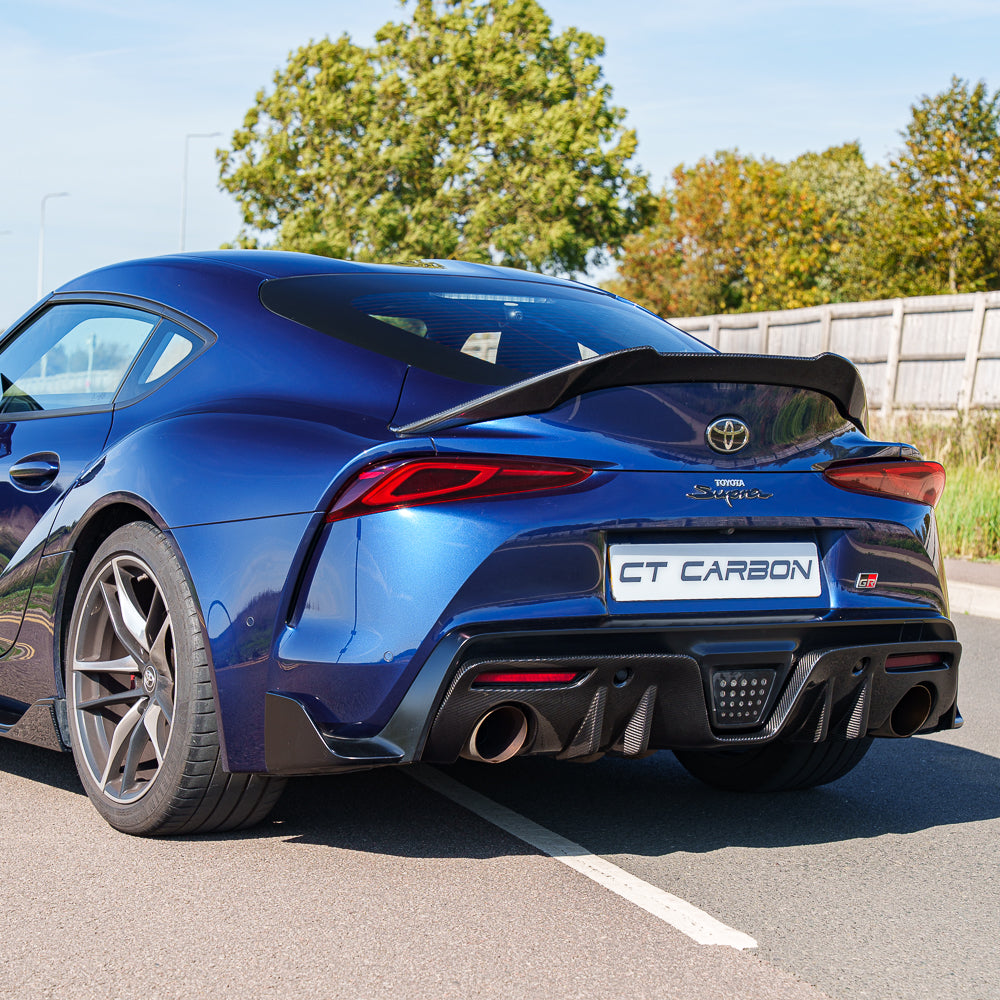 Toyota Supra 2019+ A90 Carbon Fibre Diffuser Add-On by CT Carbon, showing the sleek, textured carbon fiber rear diffuser design.