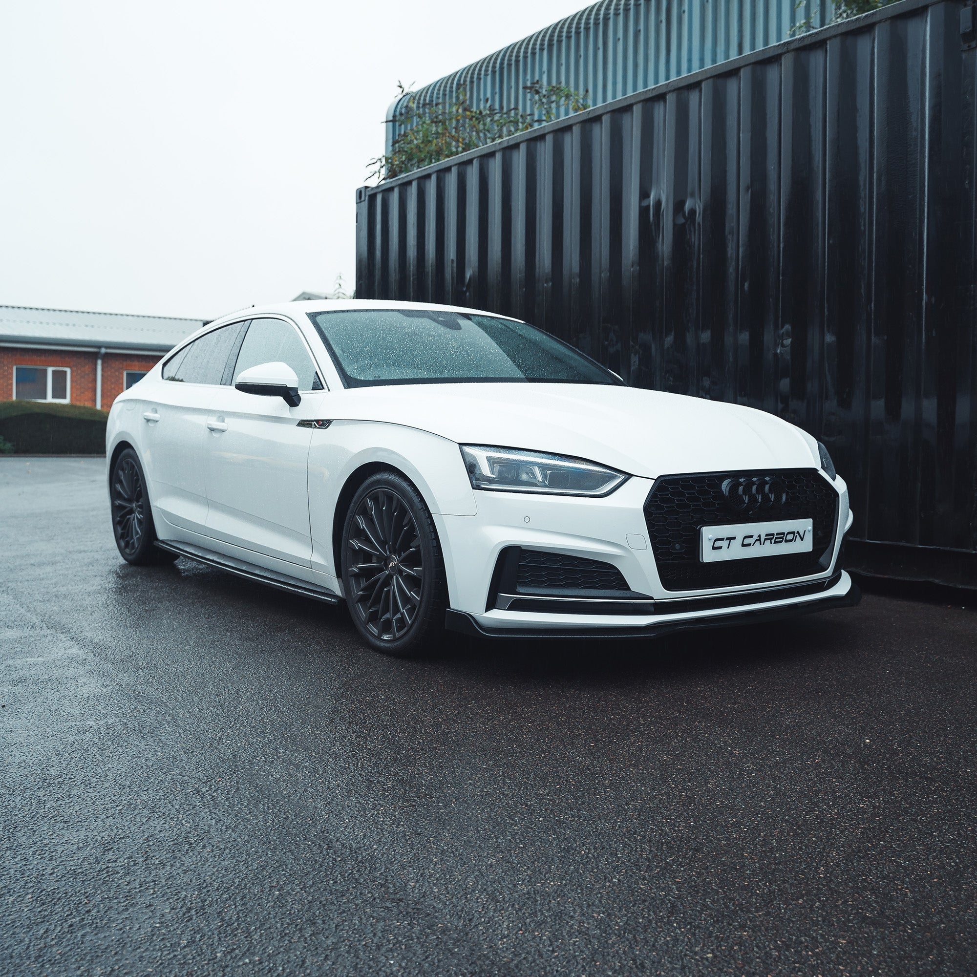 Gloss black splitter for Audi A5/S5 B9 (2016-2019) by CT Carbon, showing the aerodynamic front splitter with a sleek finish.