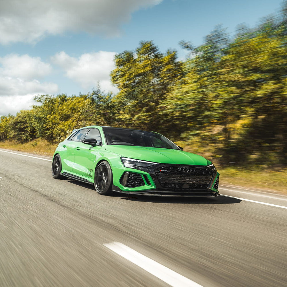 Carbon fiber splitter for Audi RS3 8Y 2022-2024, designed by CT Carbon, showcasing its sleek, aerodynamic look on the front of the car.