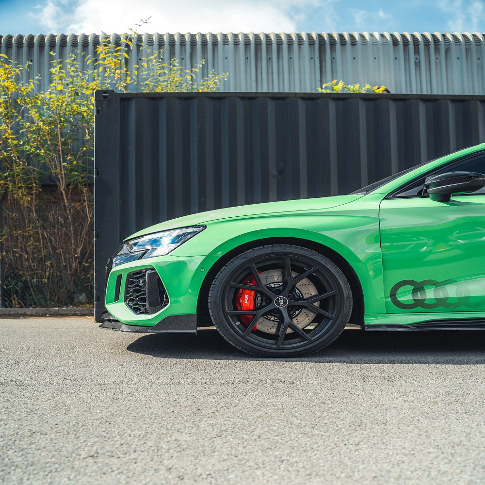 Carbon fiber splitter for Audi RS3 8Y 2022-2024 by CT Design, showing sleek, aerodynamic design on a black car.