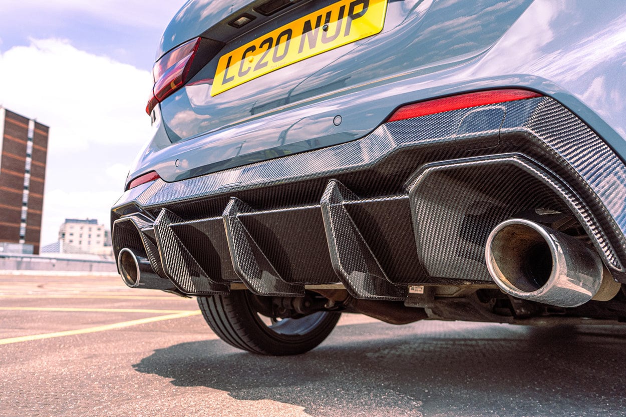 BMW 1 Series F40 carbon fiber diffuser by CT Design, showcasing sleek, aerodynamic rear car enhancement with detailed carbon fiber texture.
