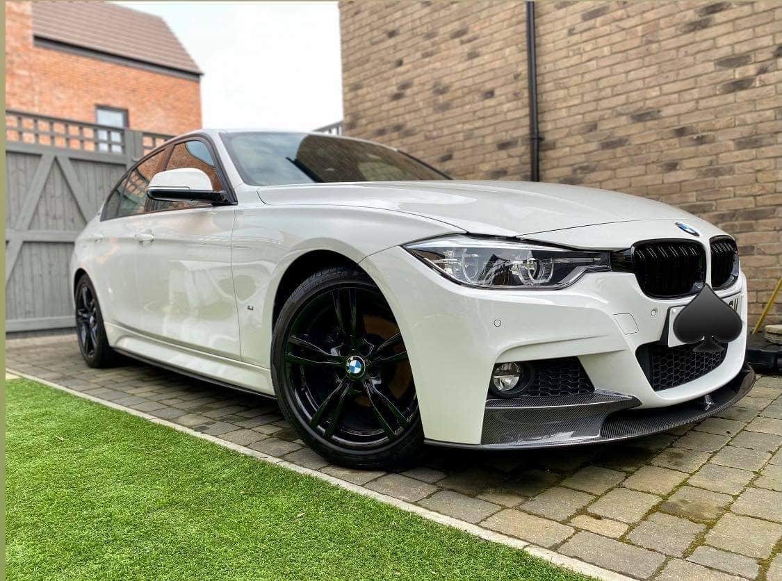 BMW 3 Series F30/F31 carbon fiber splitter by CT Carbon, V1, installed on the front bumper showcasing sporty design.