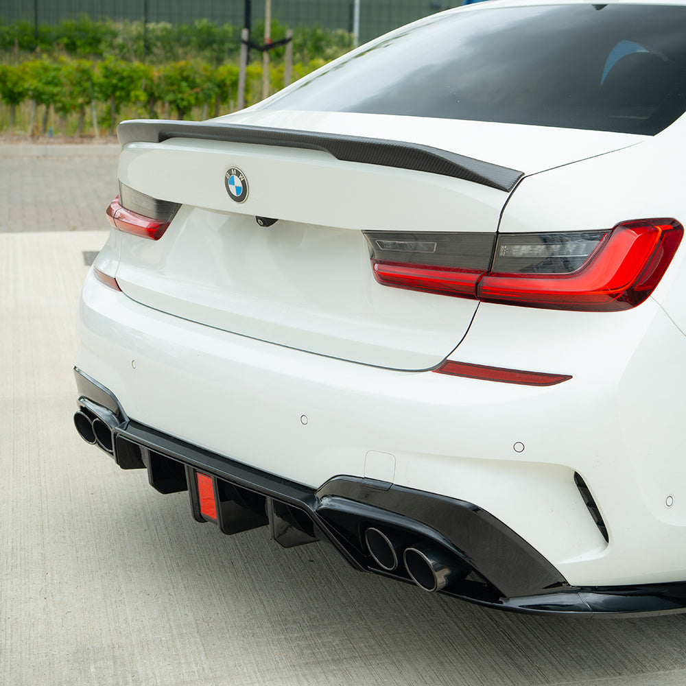 BMW G20 G21 3 Series 2019-2022 CT Carbon gloss black LED diffuser with tips installed on rear bumper.
