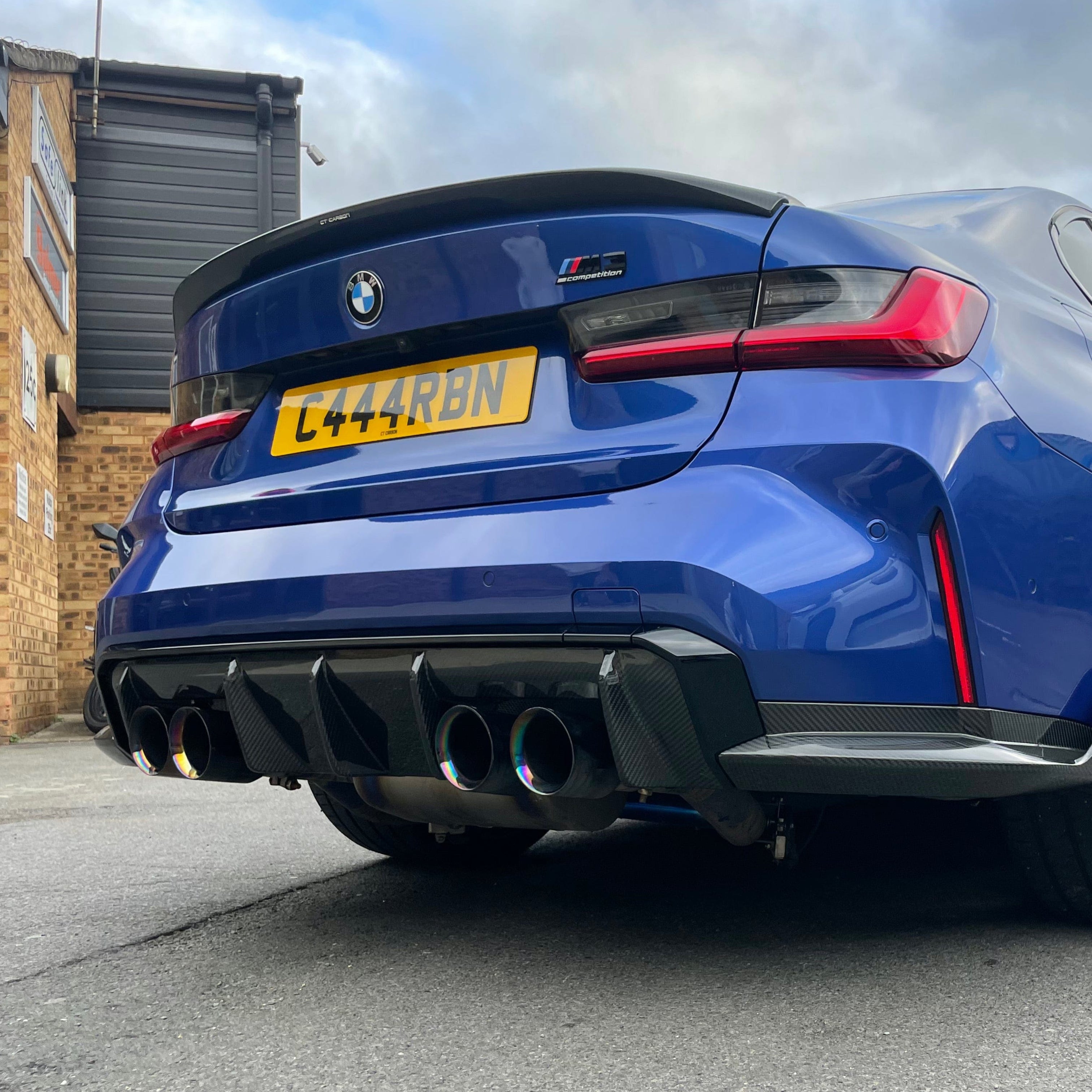 BMW M3 G80 G20 carbon fibre spoiler by CT Carbon, OEM style, showing a sleek, aerodynamic design on the car.