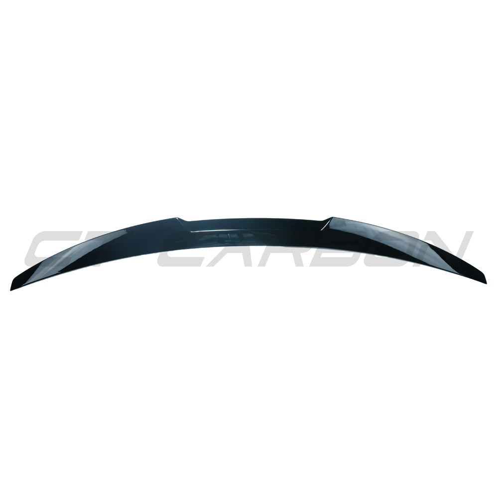 BMW 4 Series G22 2020+ gloss black spoiler by CT Carbon, showcasing the sleek aerodynamic design on the car's rear.
