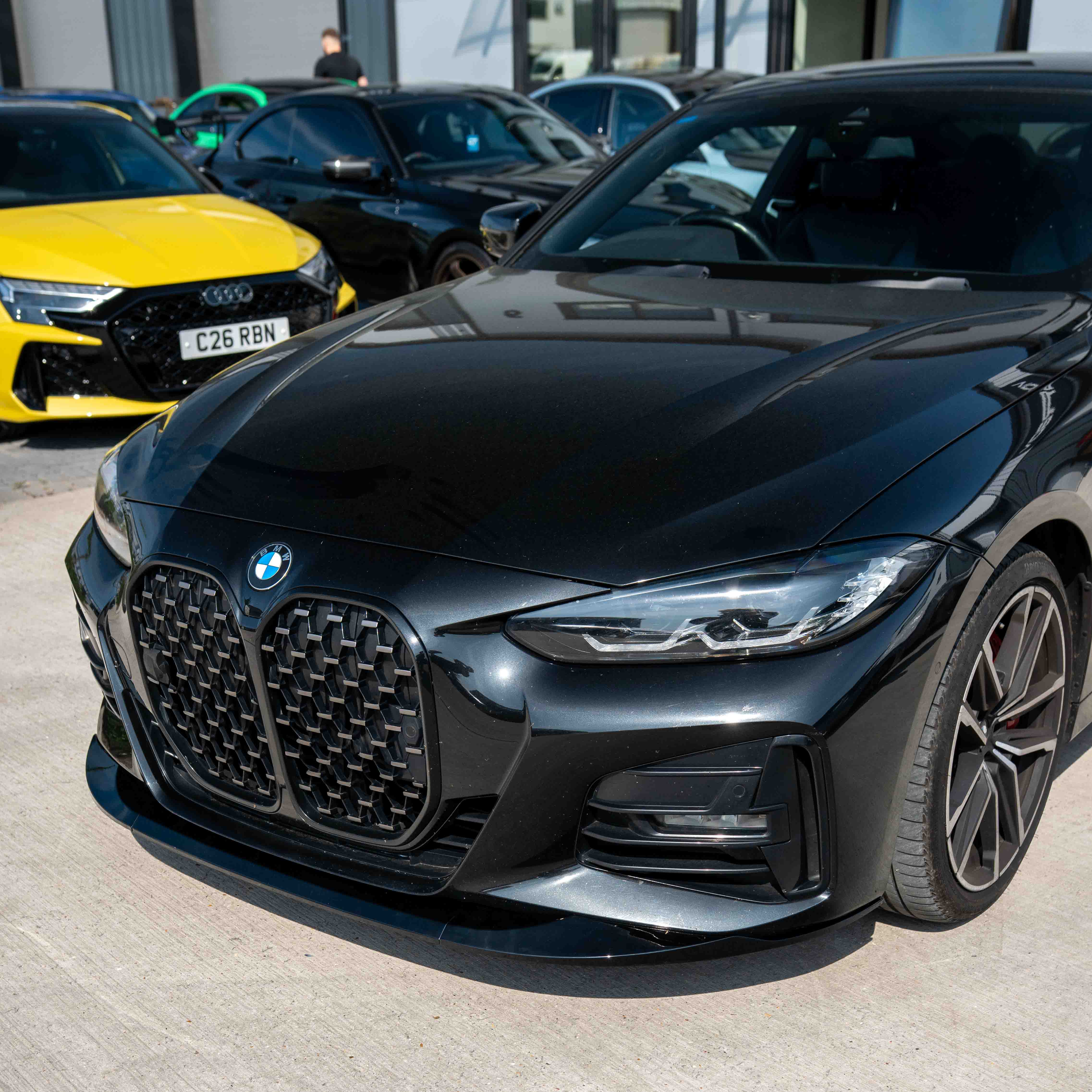 BMW 4 Series G22/G23 pre-LCI gloss black splitter by CT Carbon, showcasing the sleek aerodynamic front splitter design.
