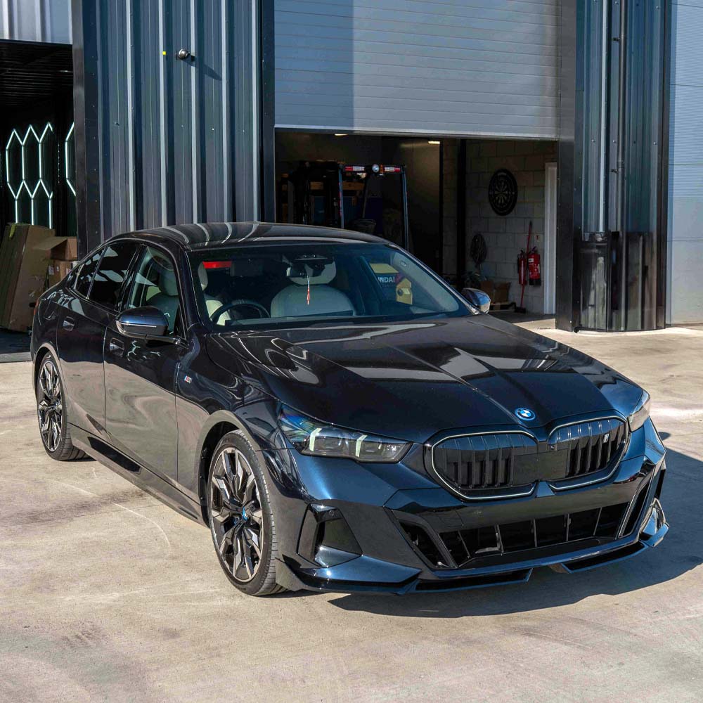 BMW 5 Series G60 and i5 2023 CT Carbon gloss black splitter installed on front bumper, showcasing sleek aerodynamic design.