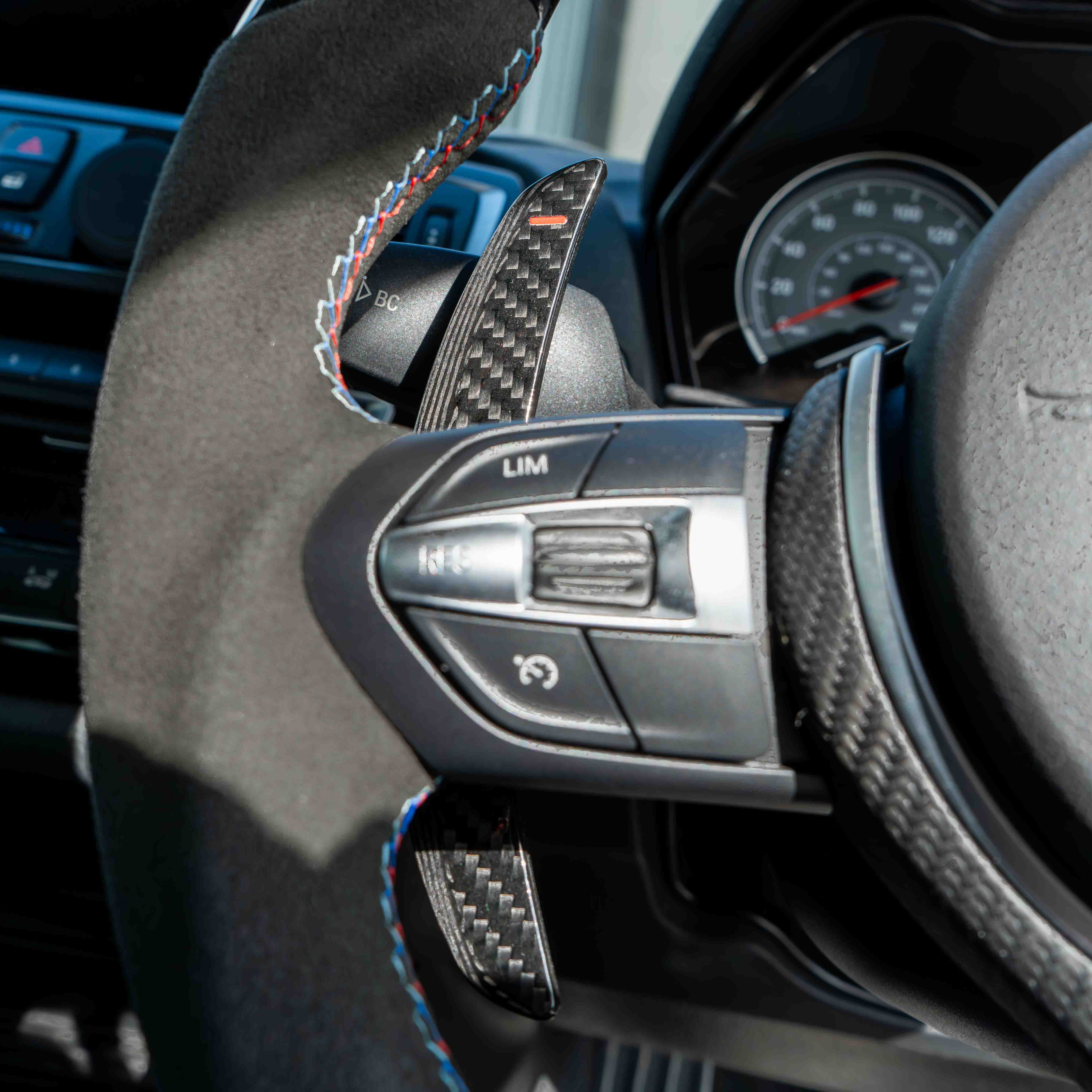 BMW carbon fiber magnetic shifter paddles by CT Carbon, featuring sleek black design and lightweight construction for sporty driving.