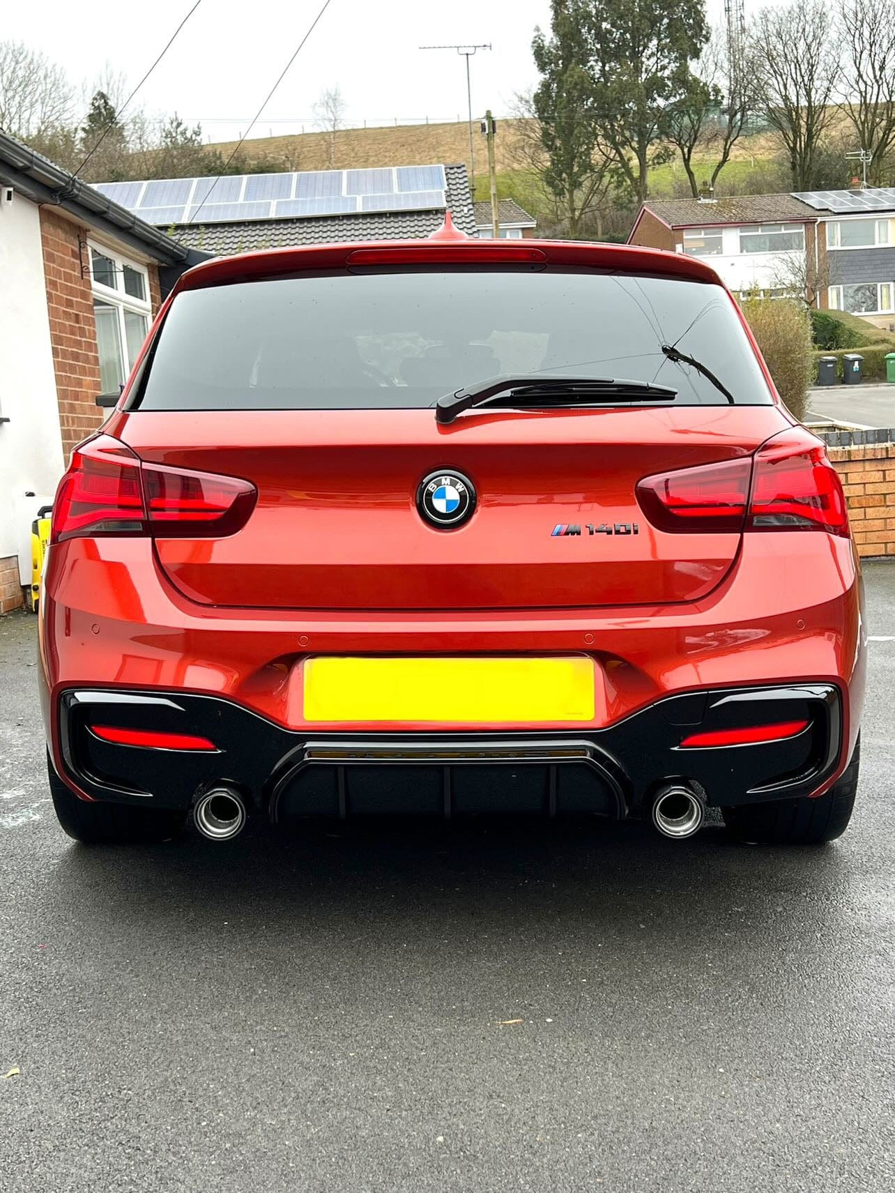 BMW F20 F21 1 Series LCI CT Carbon gloss black diffuser installed on the rear of the vehicle.