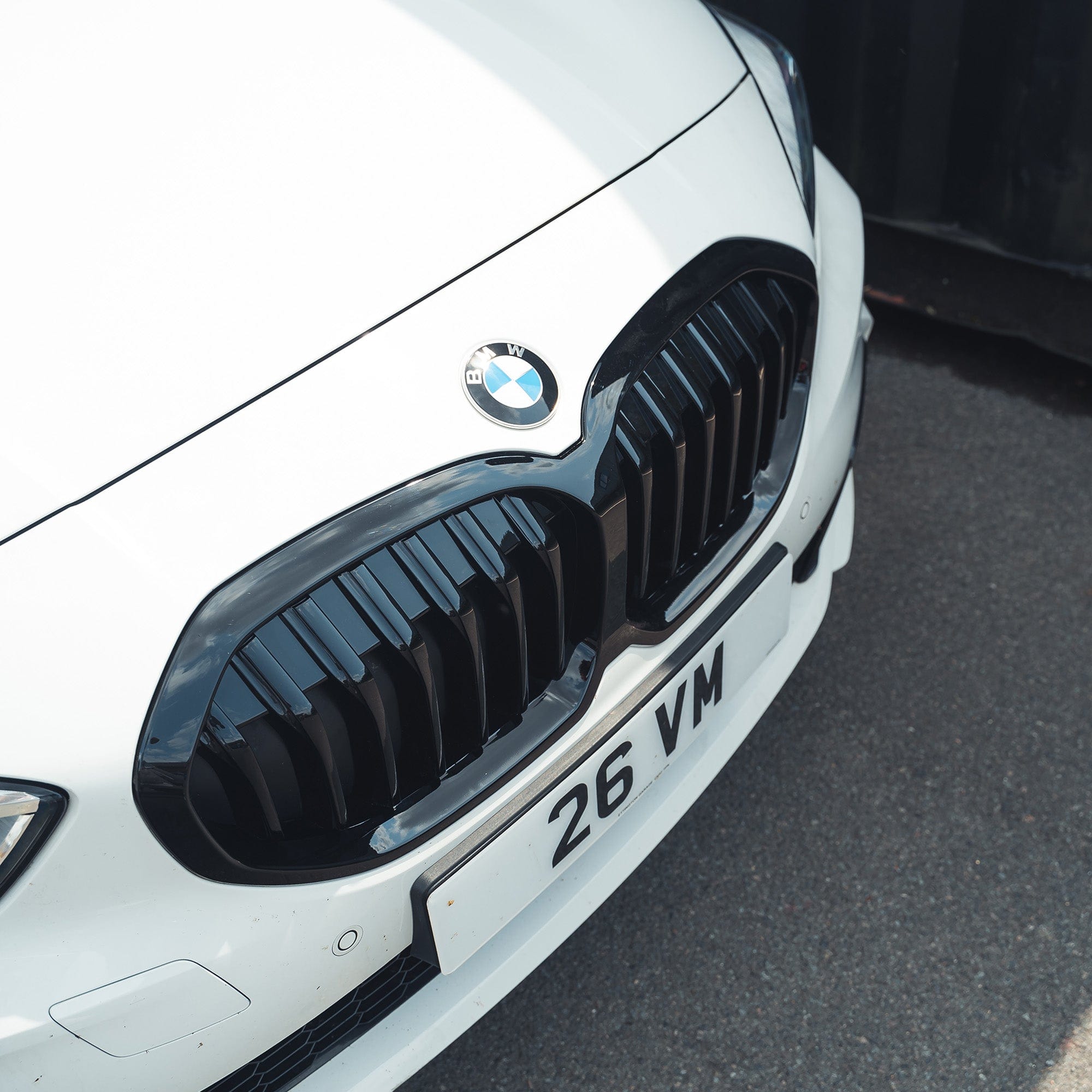BMW F40 1 Series gloss black single slat grille by CT Carbon, showcasing a sleek, high-quality automotive grille design.