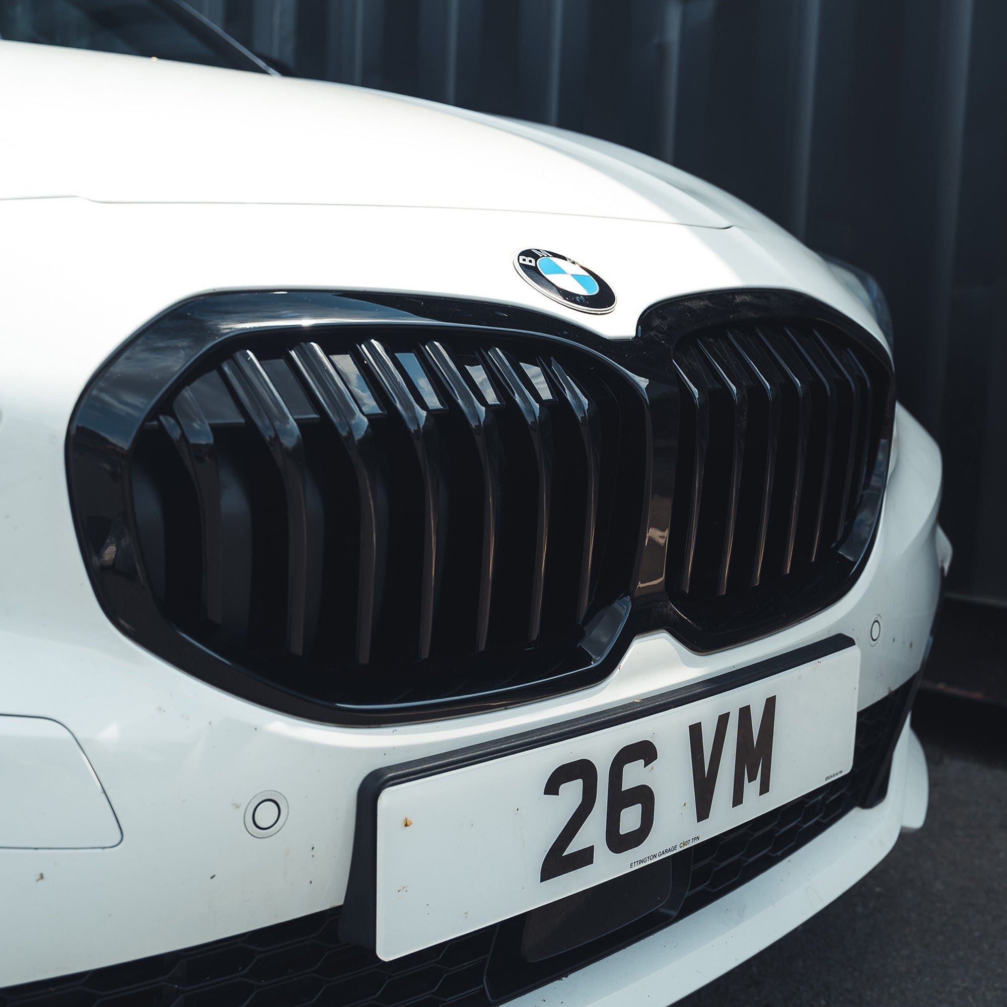 BMW F40 1 Series gloss black single slat grille by CT Carbon, close-up view of sleek black grille design on the car.