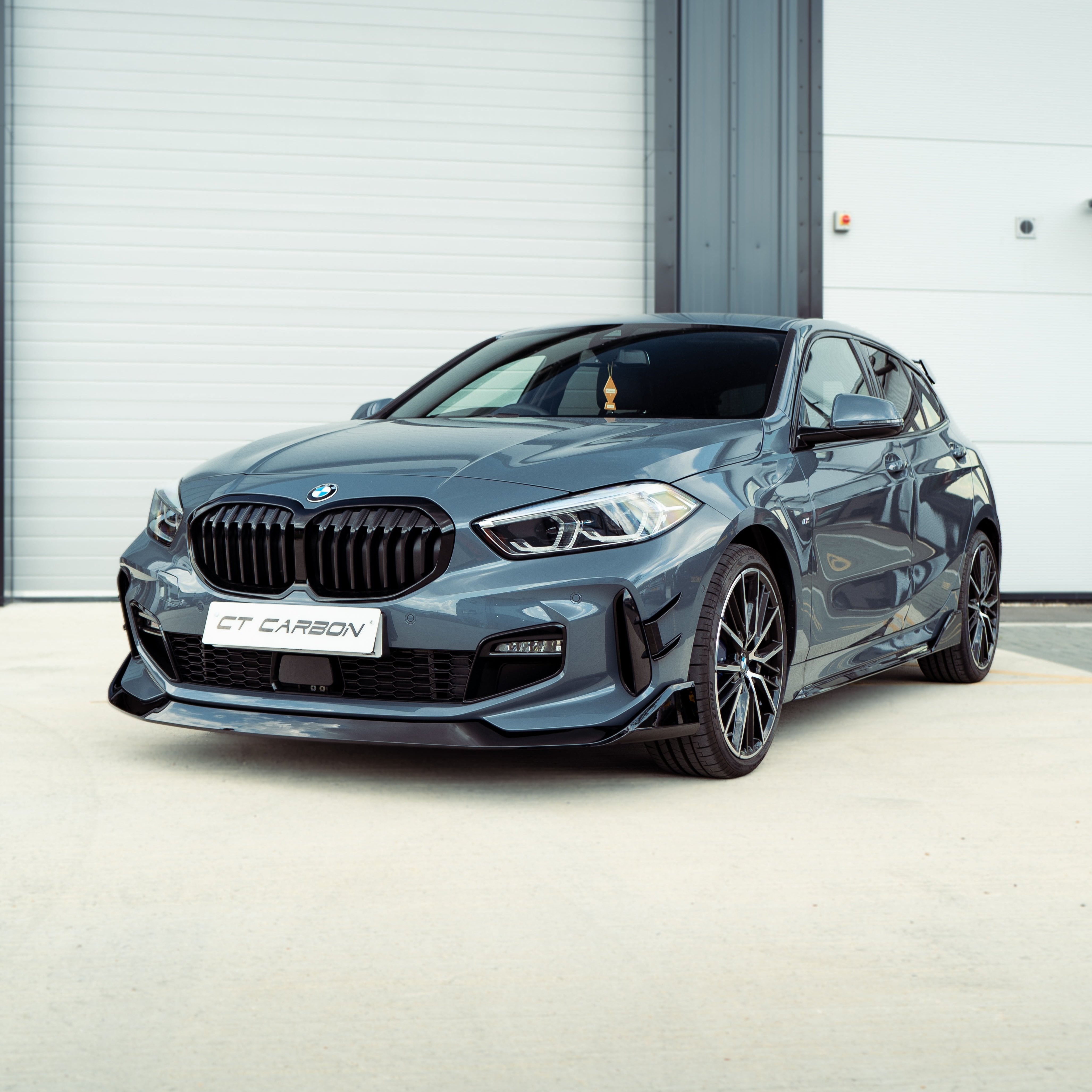 BMW F40 1 Series gloss black single slat grille by CT Carbon, showcasing sleek black grille design on a BMW vehicle.