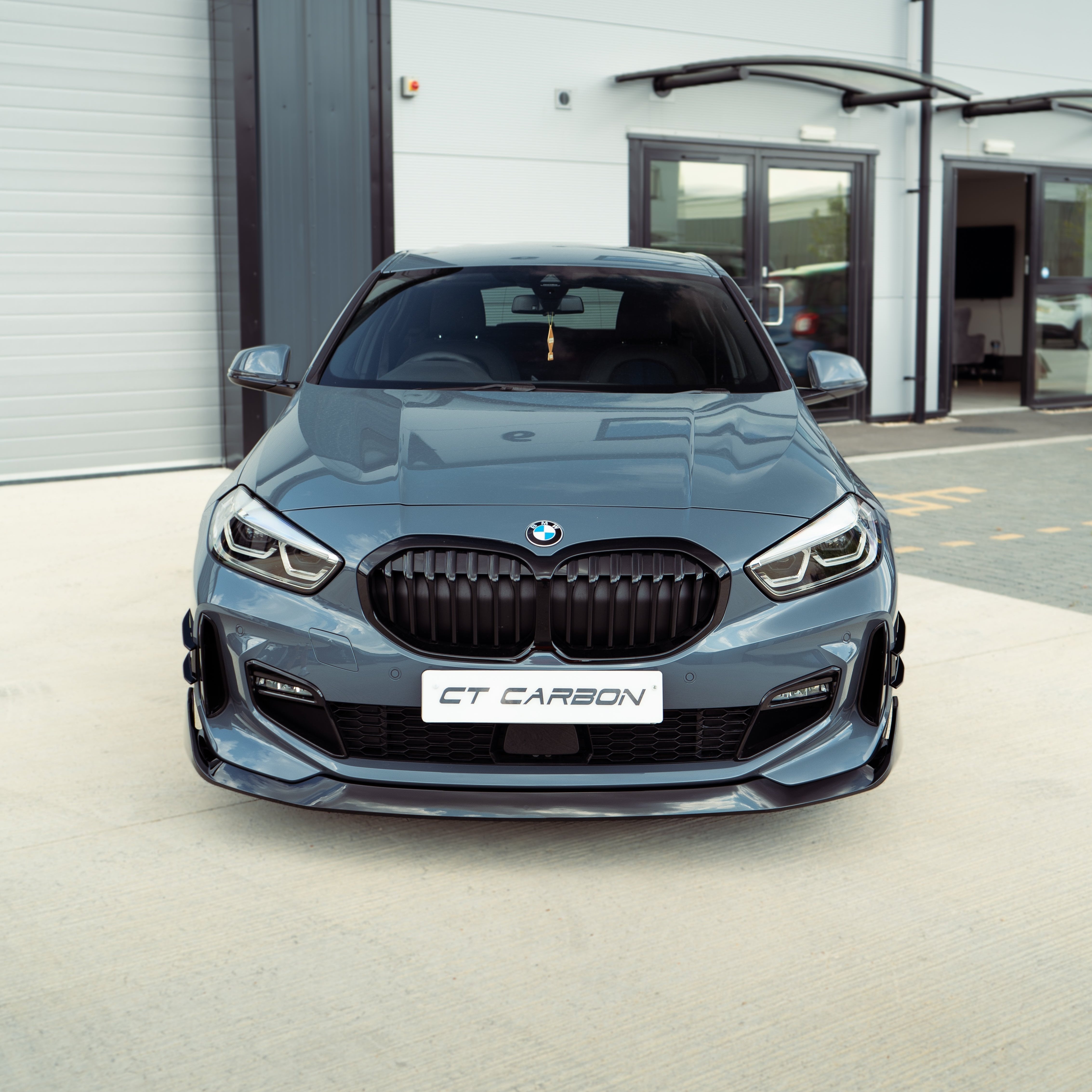 BMW F40 1 Series gloss black single slat grille by CT Carbon, showcasing the sleek black grille design on the vehicle front.