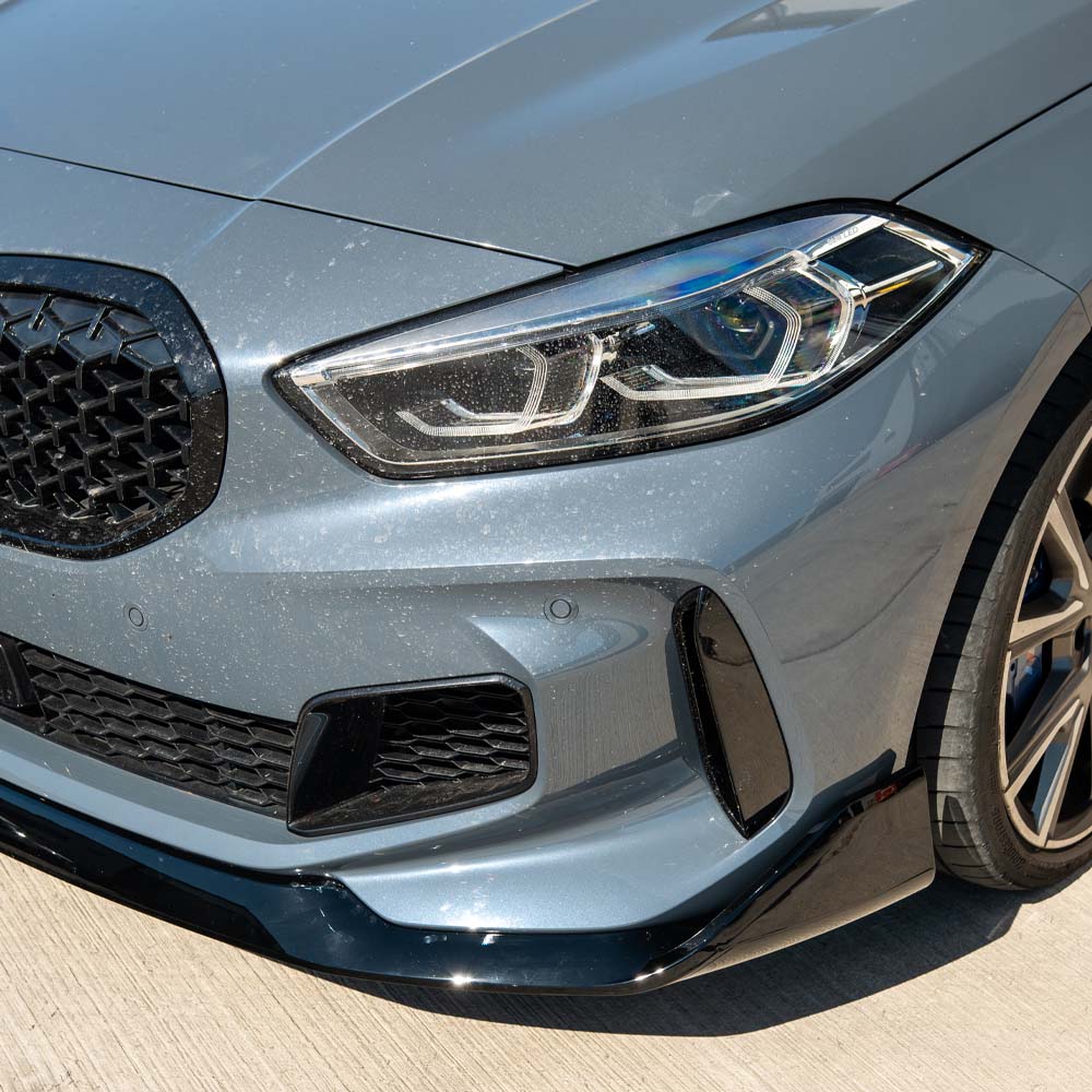 BMW F40 1 Series GLOSS BLACK Splitter by CT Carbon, V1, showcasing the sleek, aerodynamic front splitter on the vehicle.