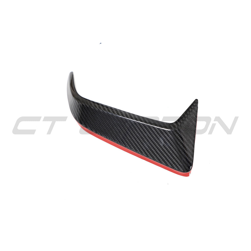 BMW F95 X5M 2023+ LCI carbon fiber rear bumper trim by CT Design, showing sleek, textured carbon fiber finish on the vehicle's rear.
