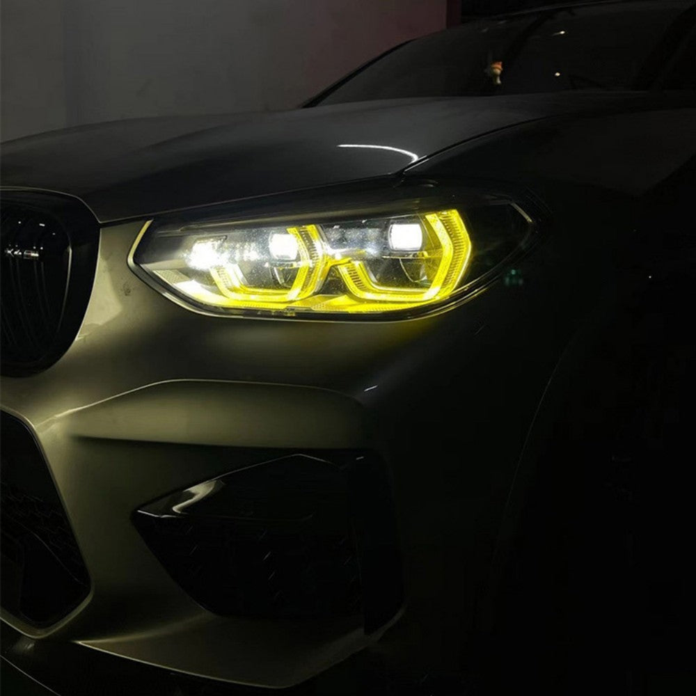 BMW G02 X4 pre-LCI yellow adaptive DRL module set by CT Carbon, showing the bright yellow daytime running lights on the vehicle.