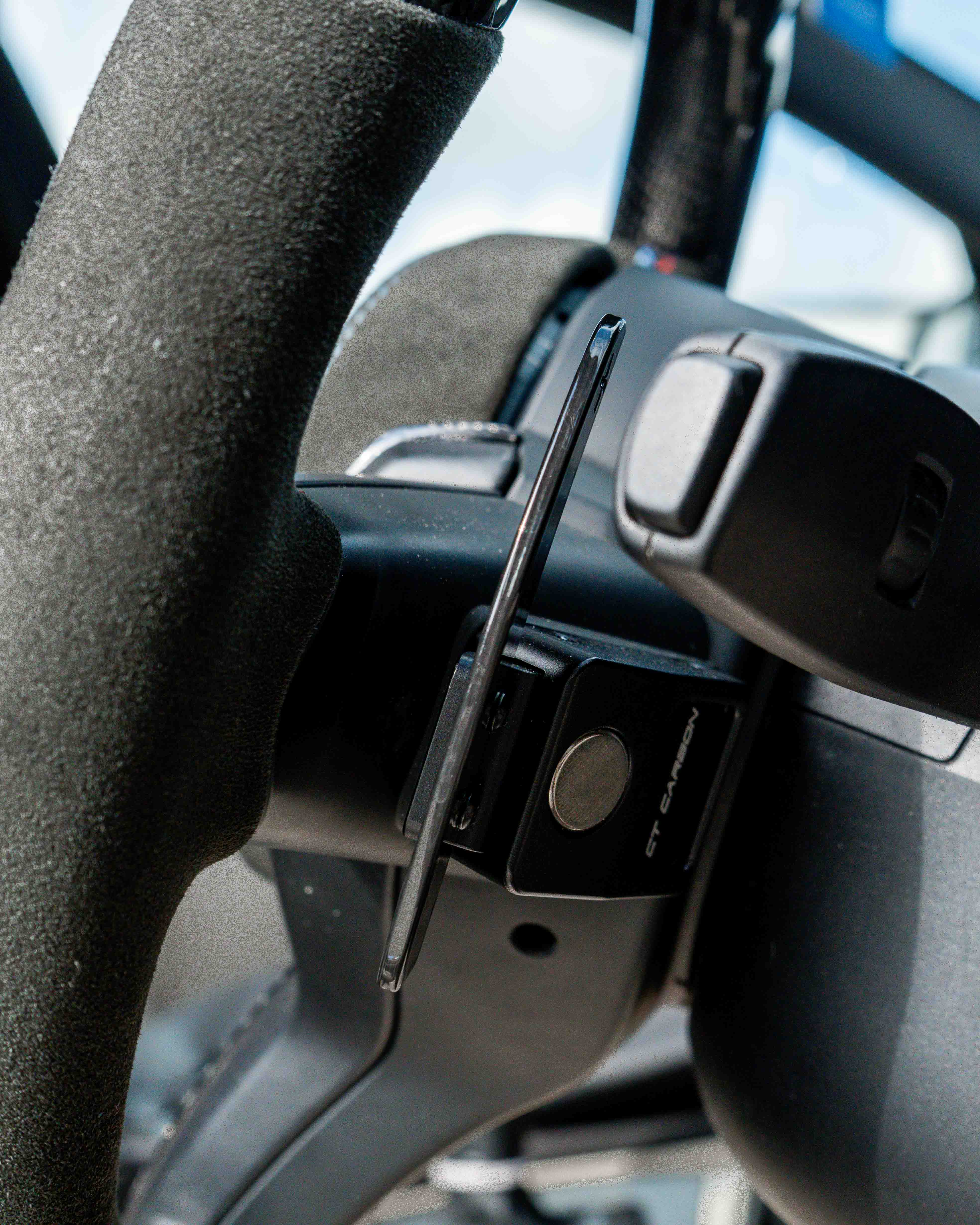 BMW Fxx carbon fiber magnetic shifter paddles by CT Carbon, close-up of sleek, lightweight racing-style car accessories.