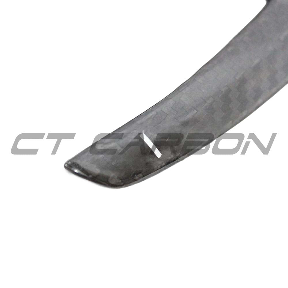 BMW Fxx carbon fibre shifter paddles by CT Carbon, close-up of sleek carbon fiber design on car accessories for sporty driving.