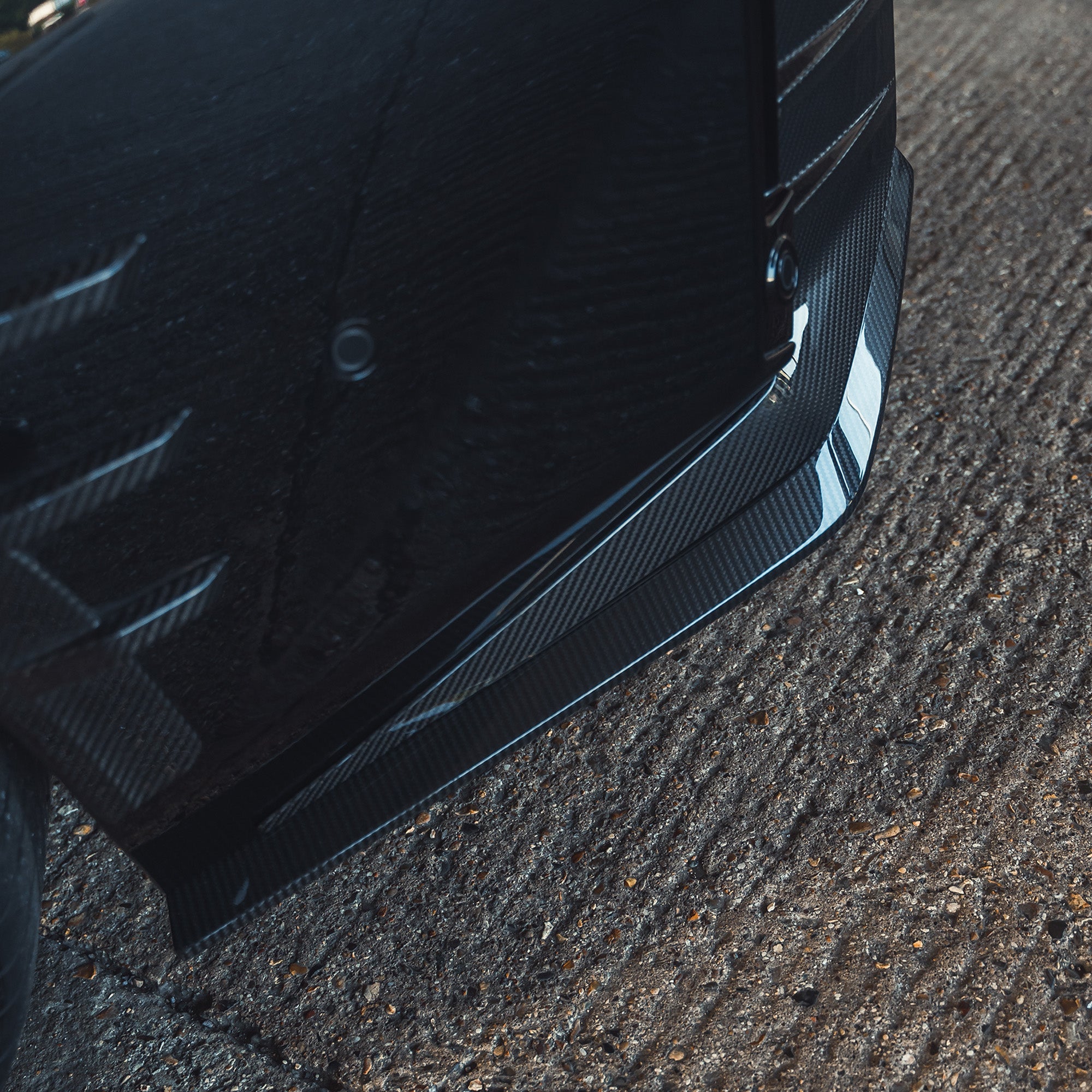 BMW G87 M2 carbon fiber rear bumper corners by CT Design, close-up showing sleek, lightweight carbon fiber finish for sporty aesthetics.
