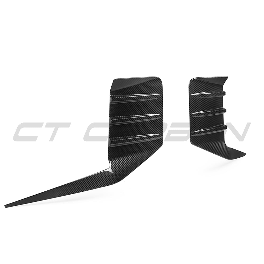 BMW G87 M2 carbon fiber rear bumper trim accessory by CT Carbon, showing close-up of sleek, textured carbon fiber finish.