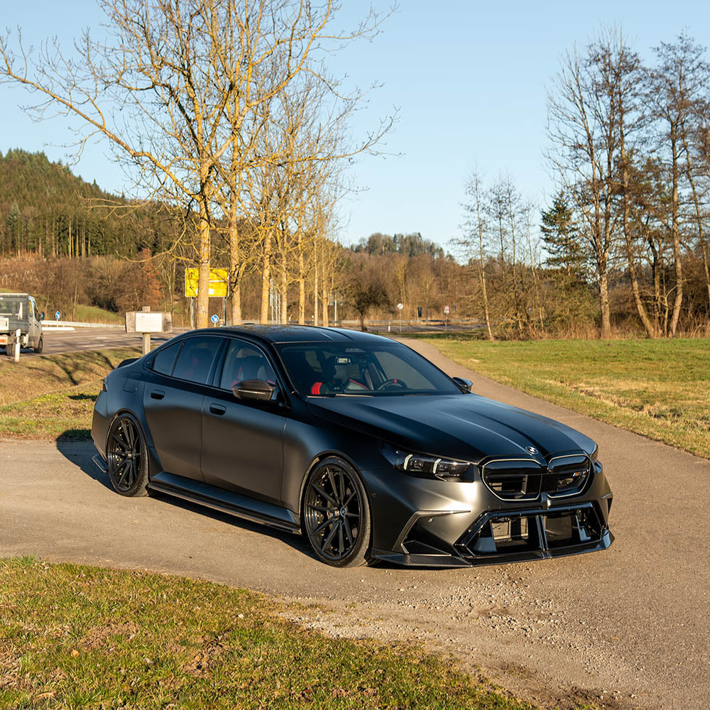 BMW G90 M5 carbon fiber full kit by CT Design, featuring aerodynamic body parts and sleek carbon fiber accents.