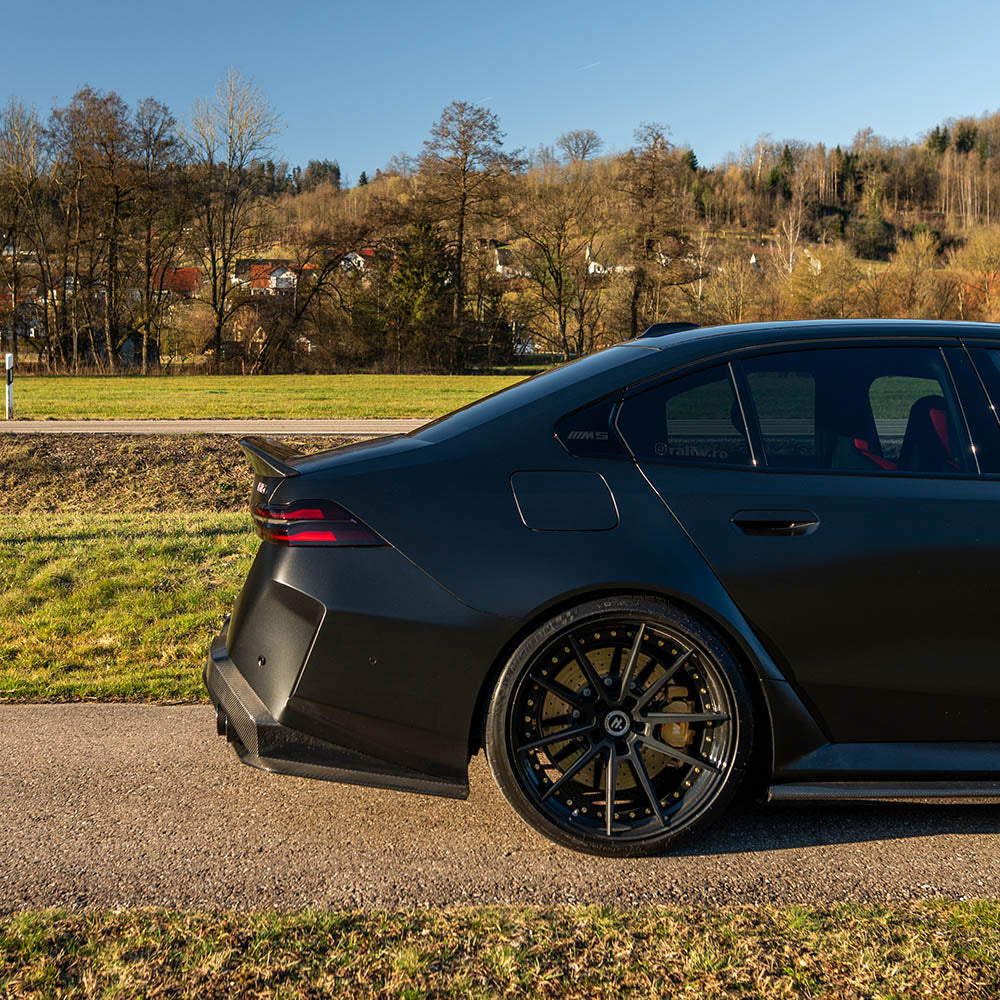 BMW G90 M5 carbon fiber full kit by CT Design, featuring sleek carbon fiber spoiler and body enhancements for a sporty look.