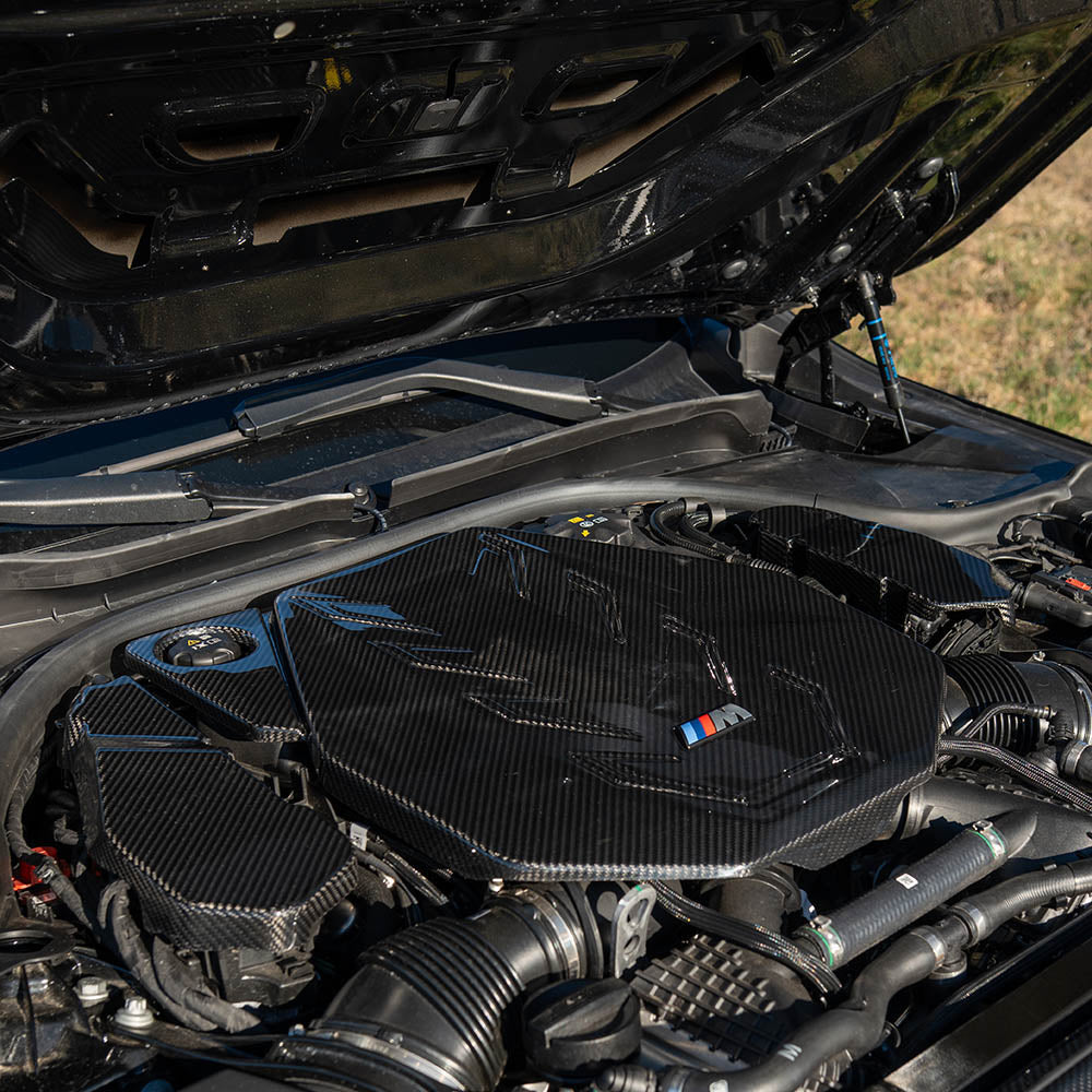 BMW G90 G99 M5 2024 carbon fiber engine bay covers by CT Carbon, showcasing sleek, lightweight accessory for engine bay enhancement.
