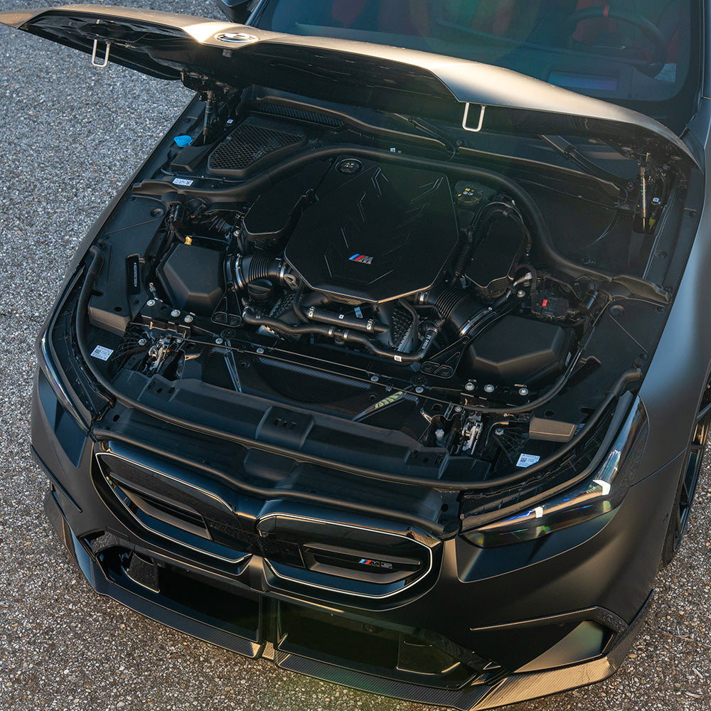 BMW G90 G99 M5 2024 carbon fiber slam panel accessory by CT Carbon, showcasing the lightweight, textured carbon fiber surface.