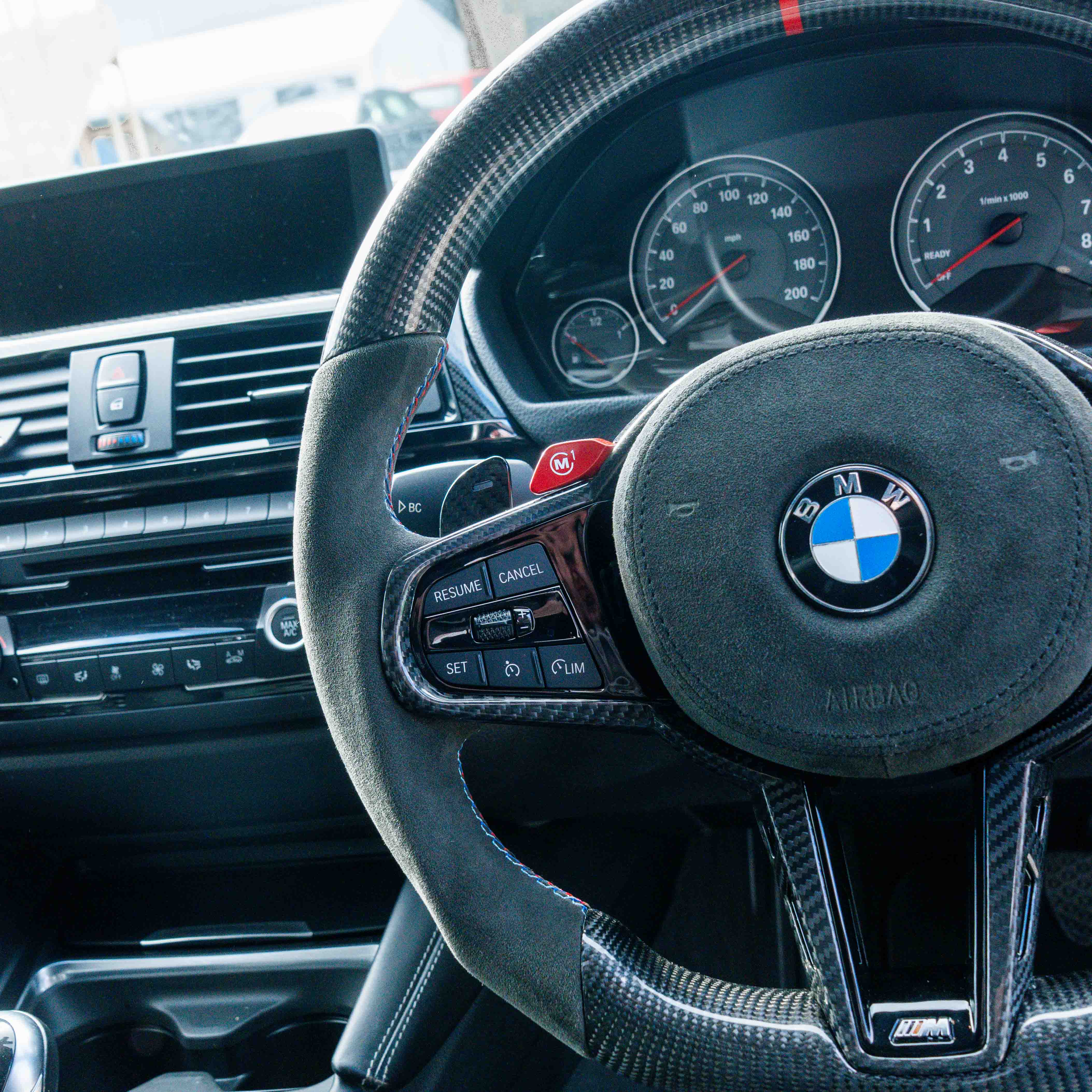 BMW Gxx carbon fibre magnetic shifter paddles by CT Carbon, close-up view showing sleek, lightweight design and textured finish.