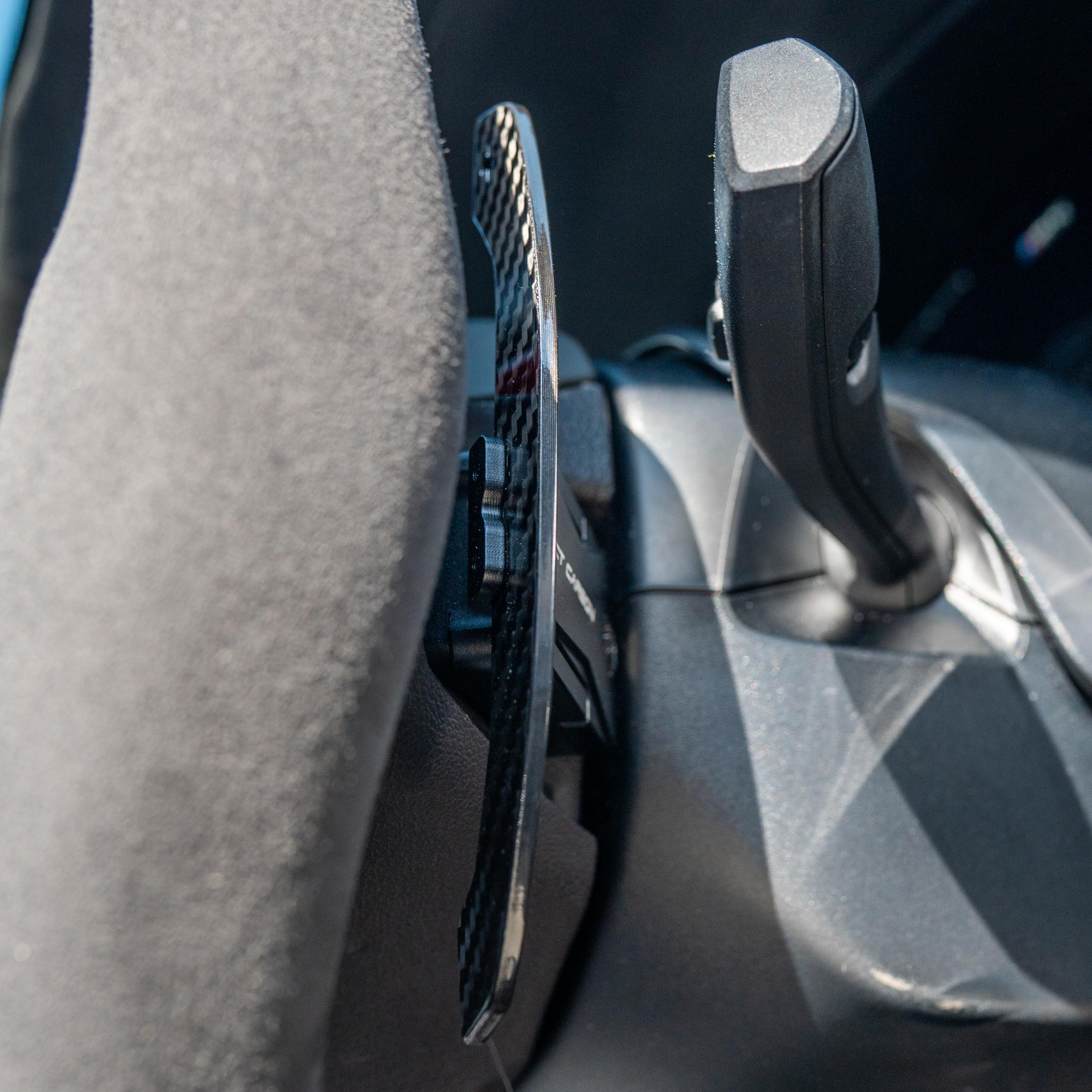 BMW Gxx carbon fibre magnetic shifter paddles by CT Carbon, close-up of sleek, lightweight racing-inspired car accessories.