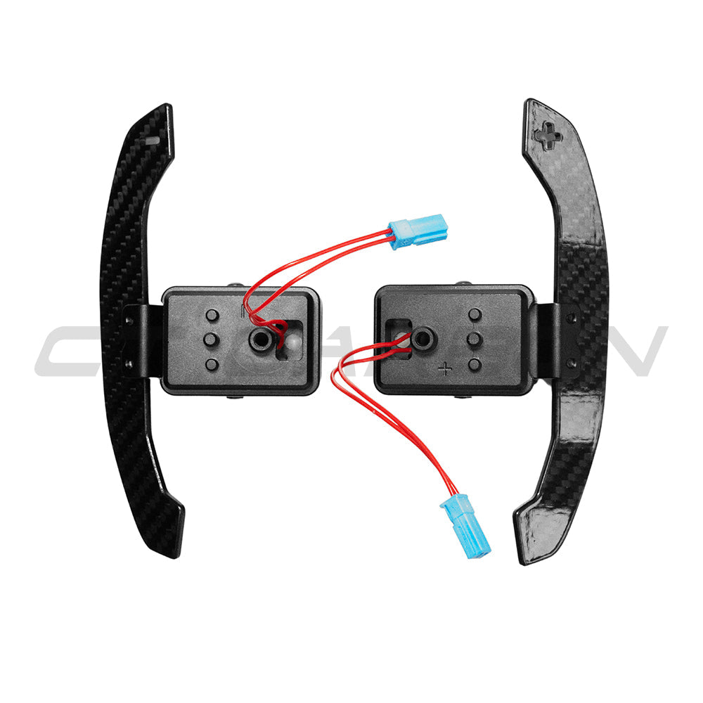 BMW Gxx carbon fiber magnetic shifter paddles by CT Carbon, showing sleek black carbon fiber design with magnetic attachment points.