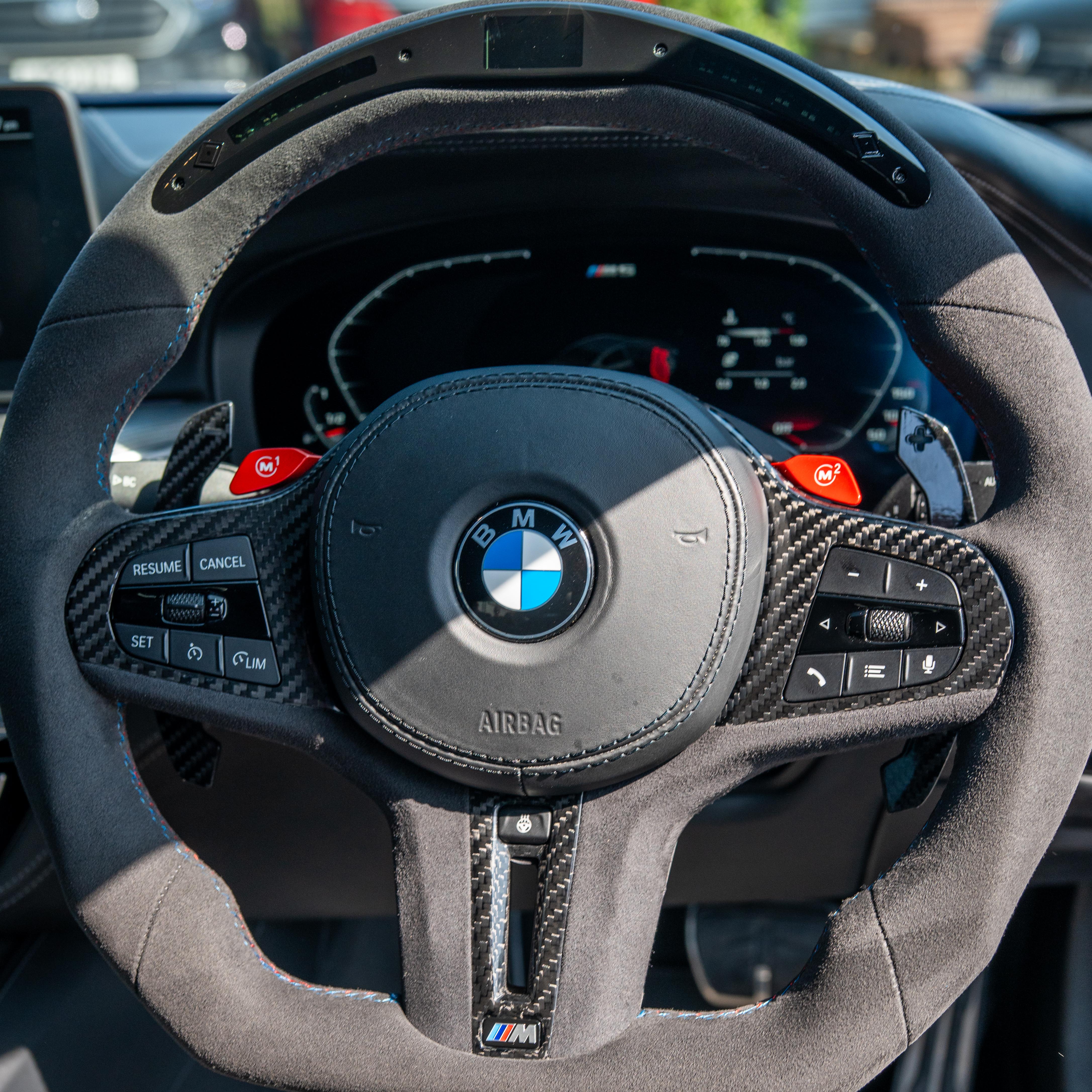 BMW Gxx carbon fiber magnetic shifter paddles by CT Carbon, showing sleek, lightweight design and textured carbon fiber surface.