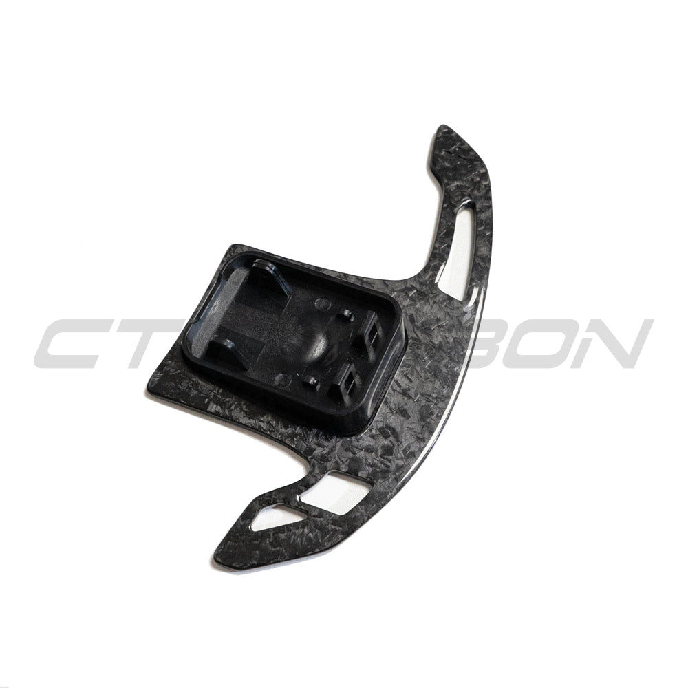 BMW Gxx forged carbon fiber shifter paddles by CT Carbon, close-up of sleek, lightweight automotive accessories with textured carbon finish.
