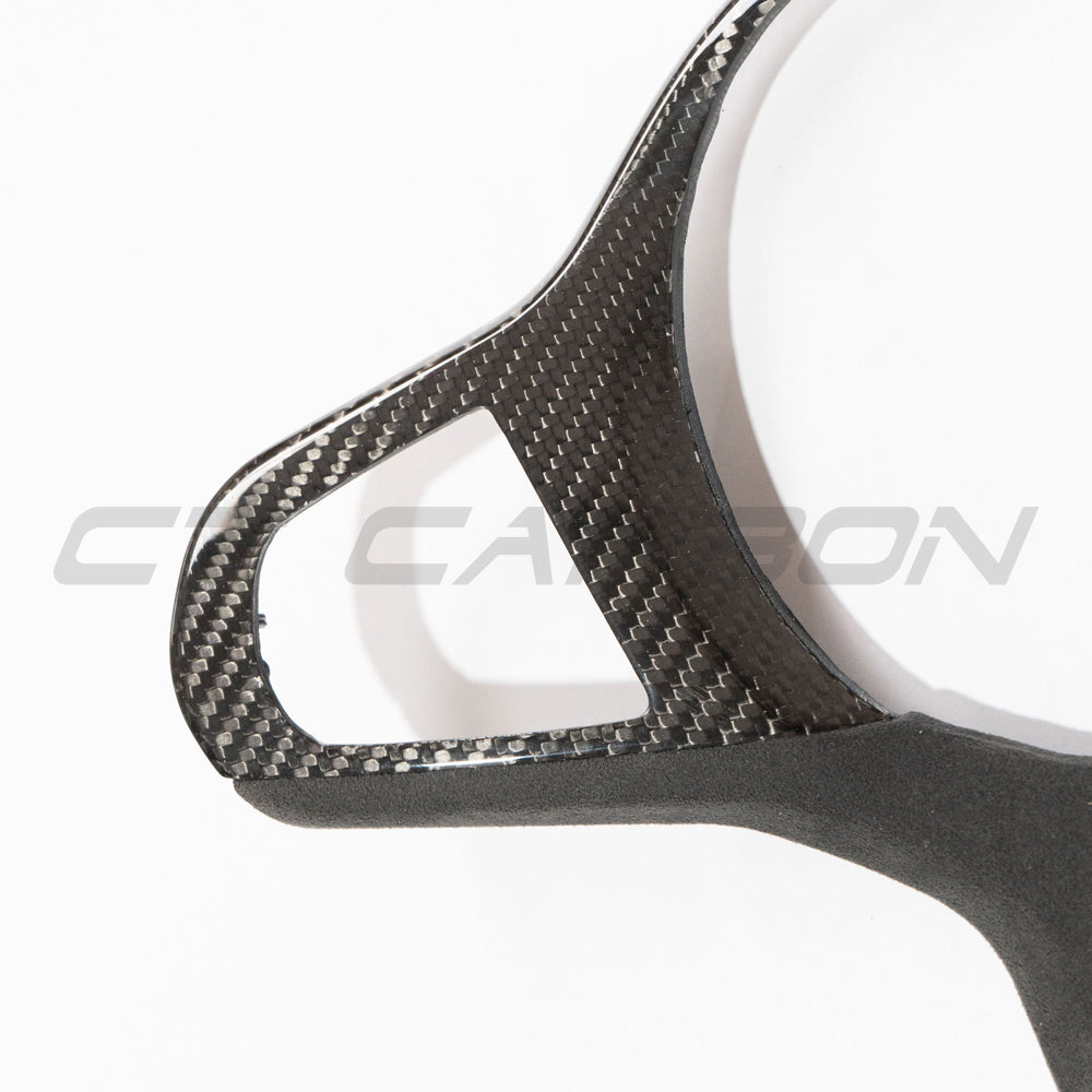BMW Gxx M carbon fiber steering wheel trim with heating feature, accessory by CT Carbon, showcasing sleek textured finish.