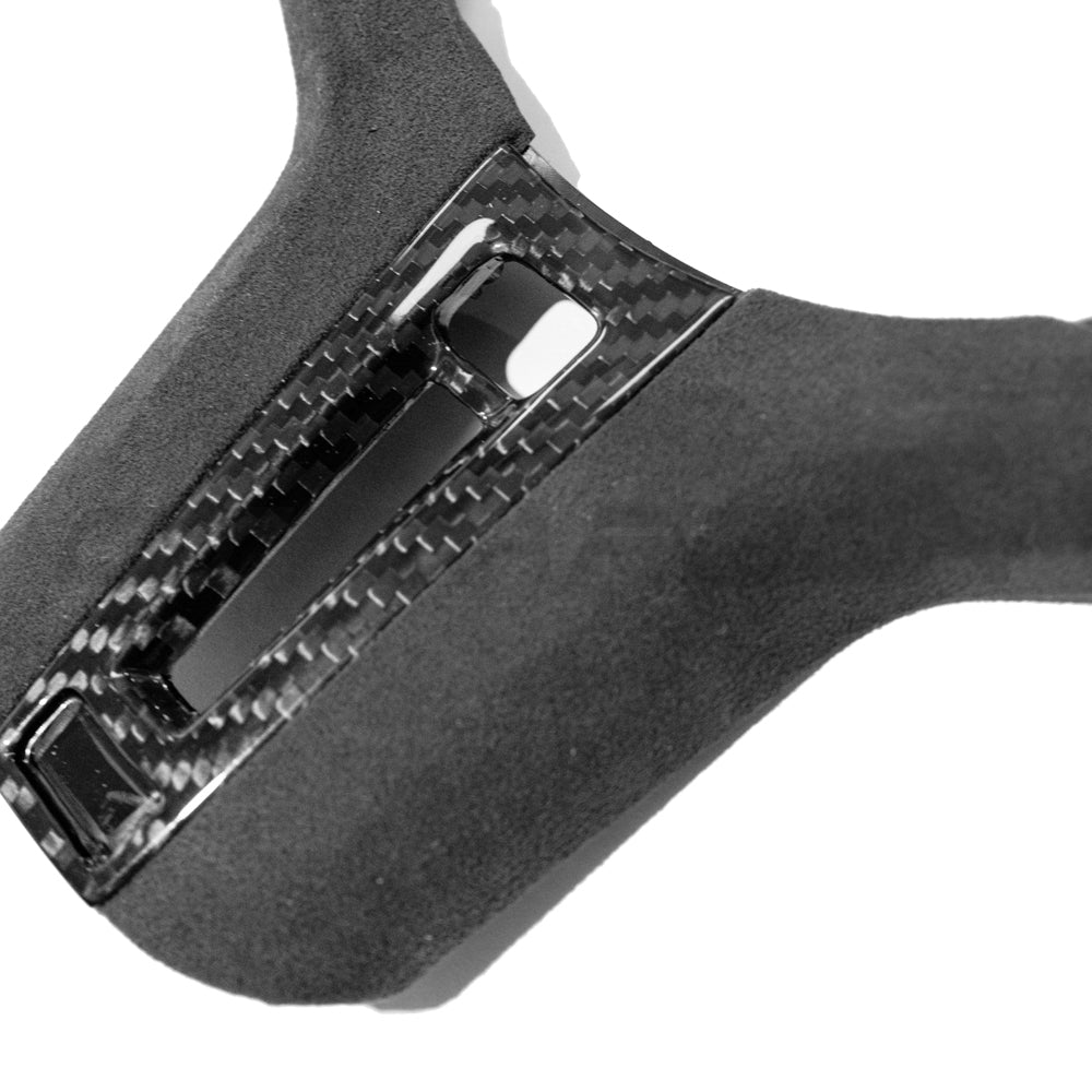 BMW Gxx M carbon fiber steering wheel trim with heating and accessory controls, designed by CT Carbon for enhanced interior style.