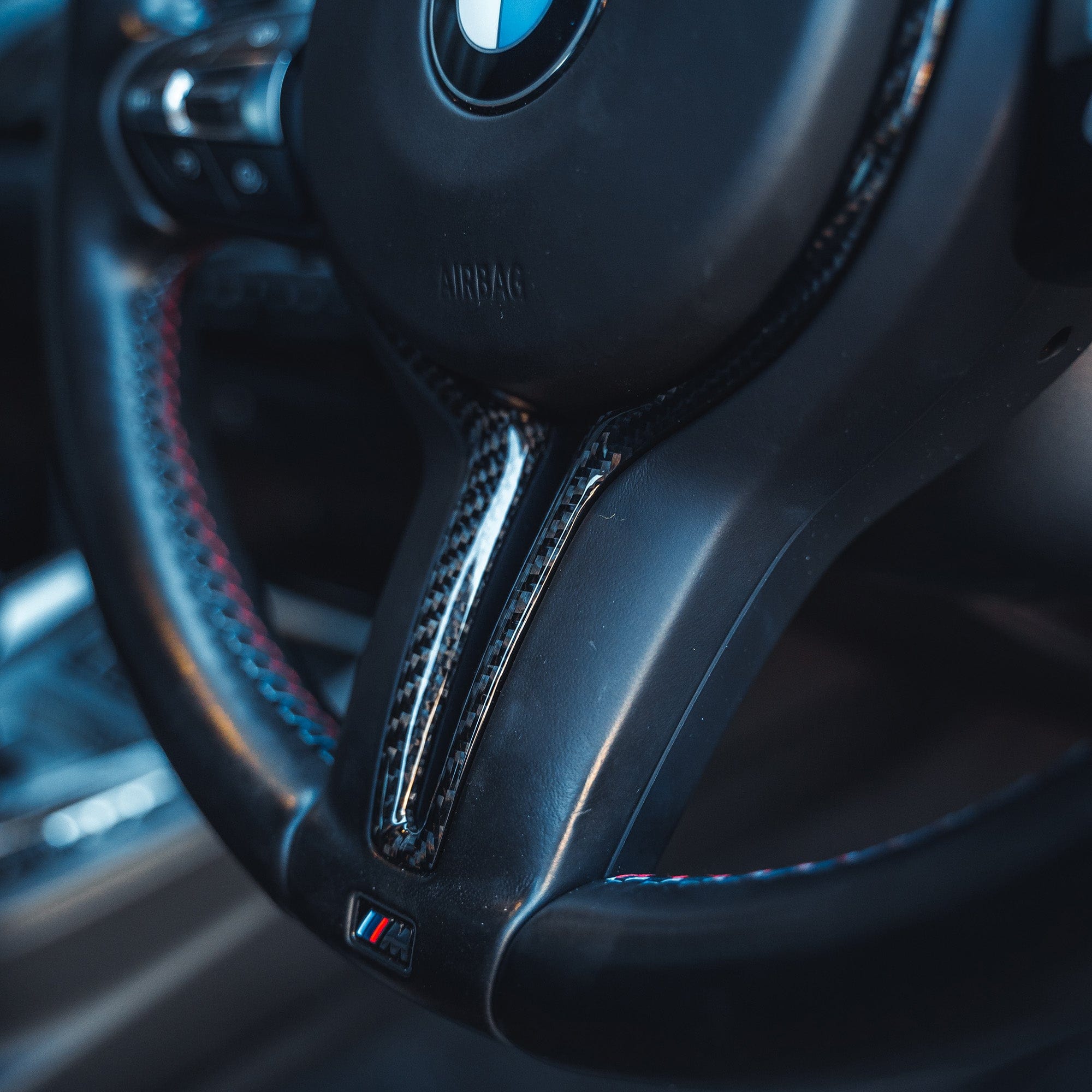 BMW M Fxx carbon fiber steering wheel trim by CT Carbon, designed for 2012-2020 M models, close-up view of sleek interior accessory.